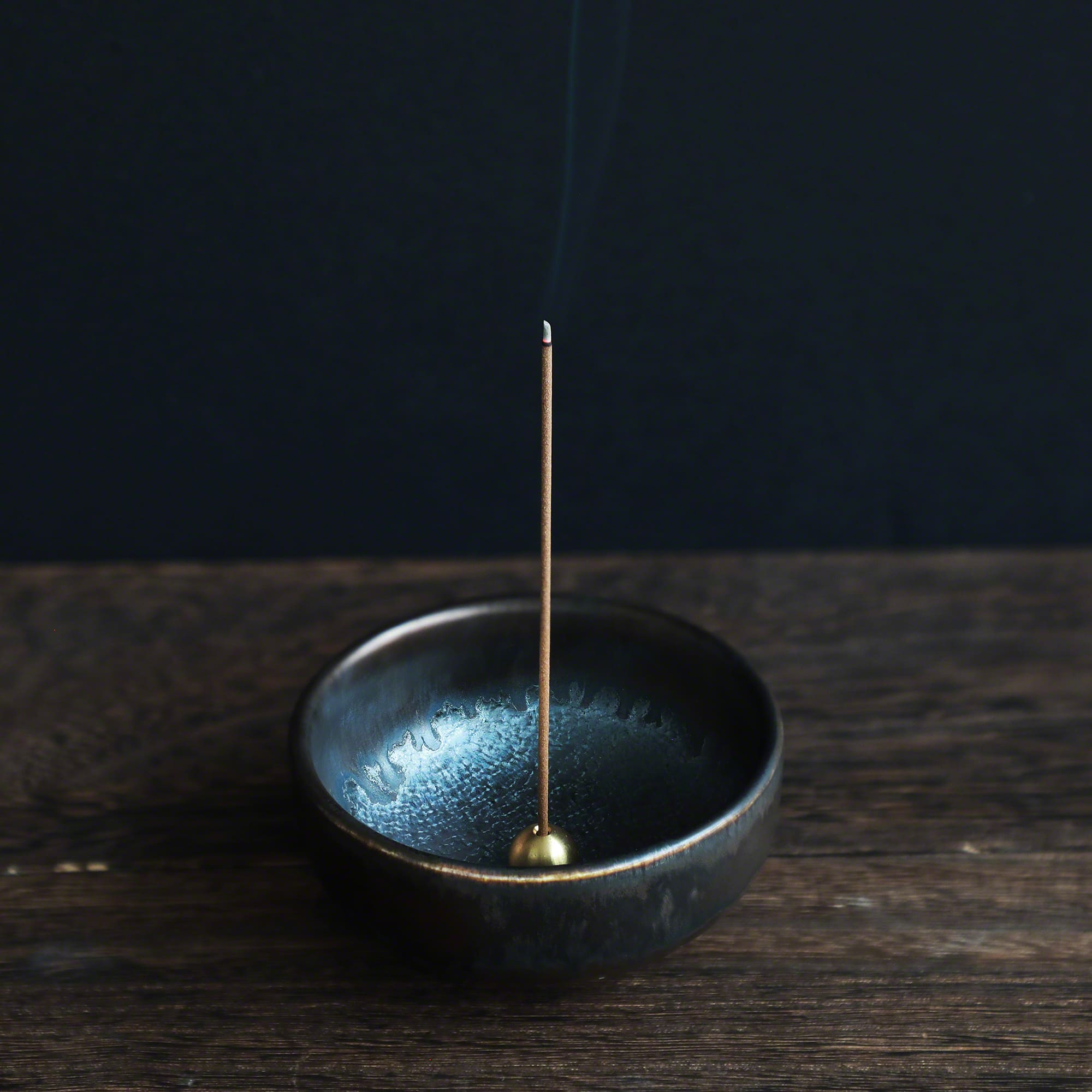 Patchouli incense sticks burning in an incense holder