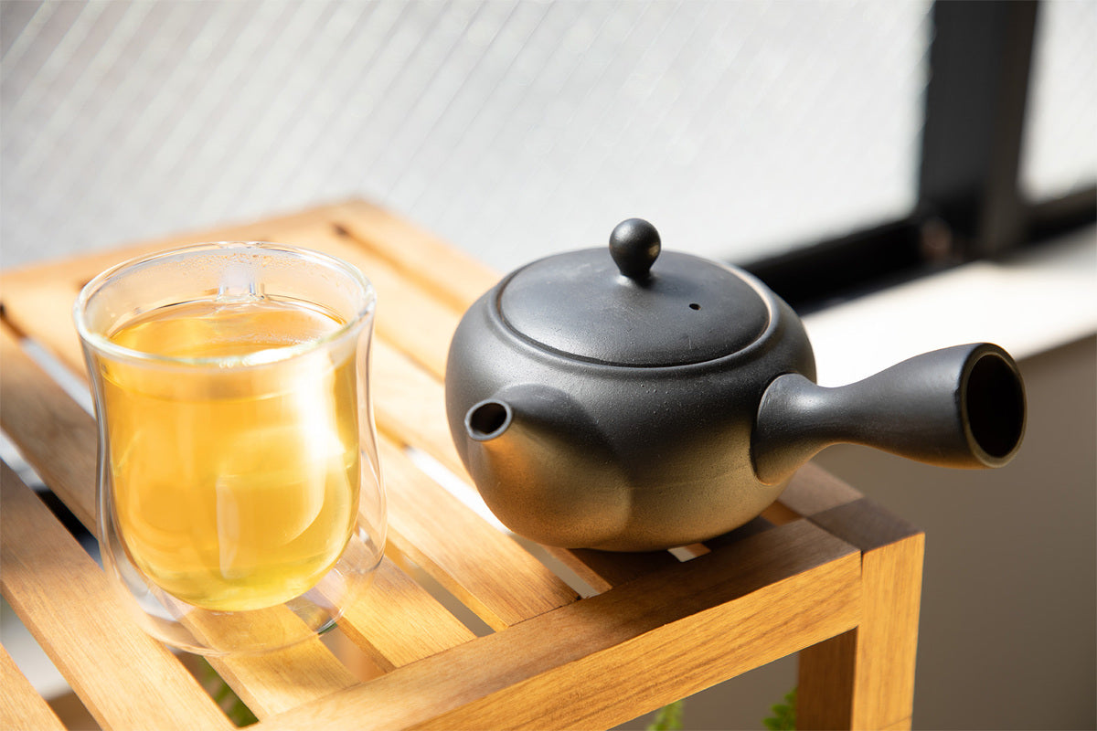 ceramic japanese tea pot with a glass of tea