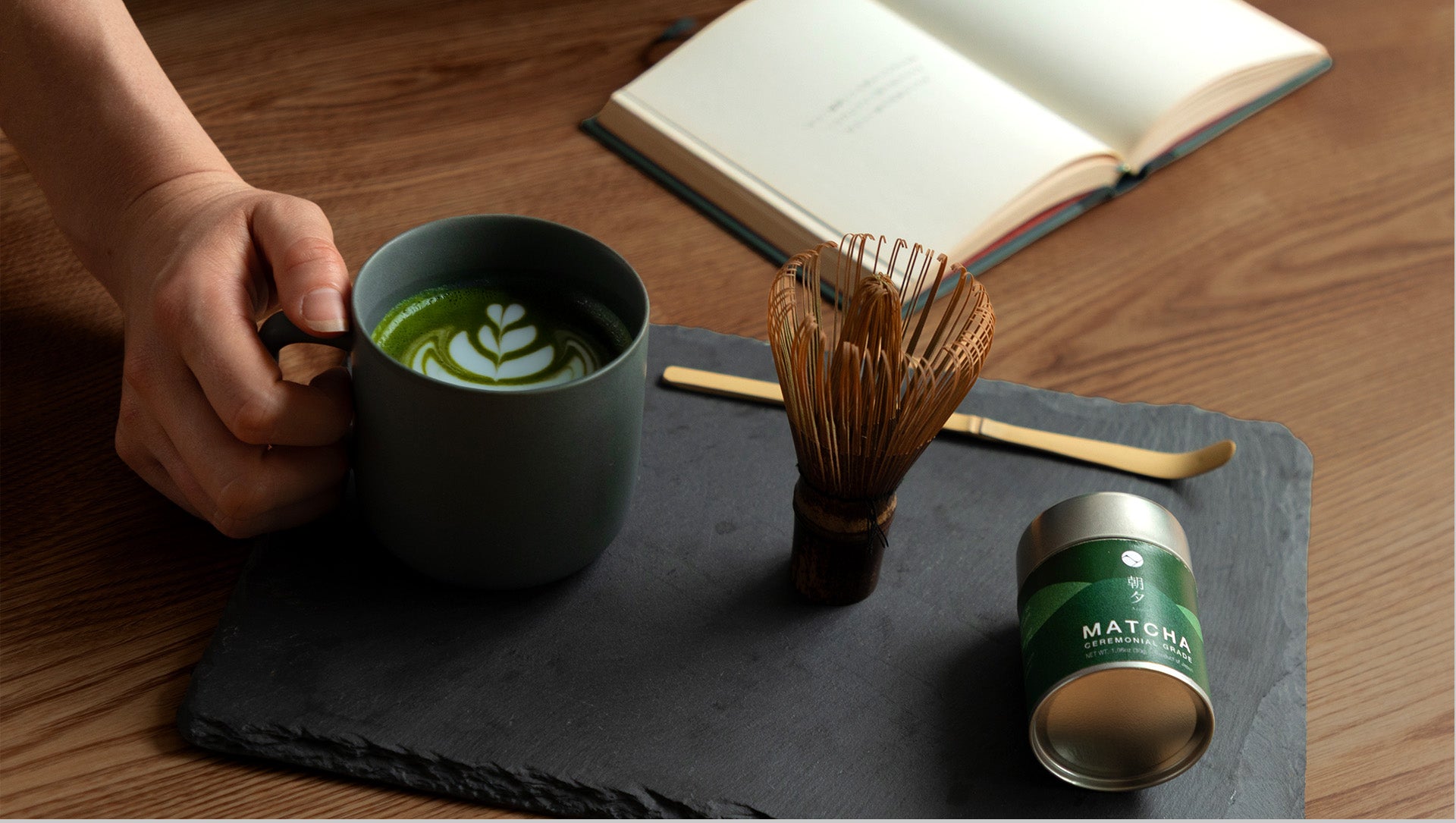 Ceremonial Matcha can  and latte on a black slate