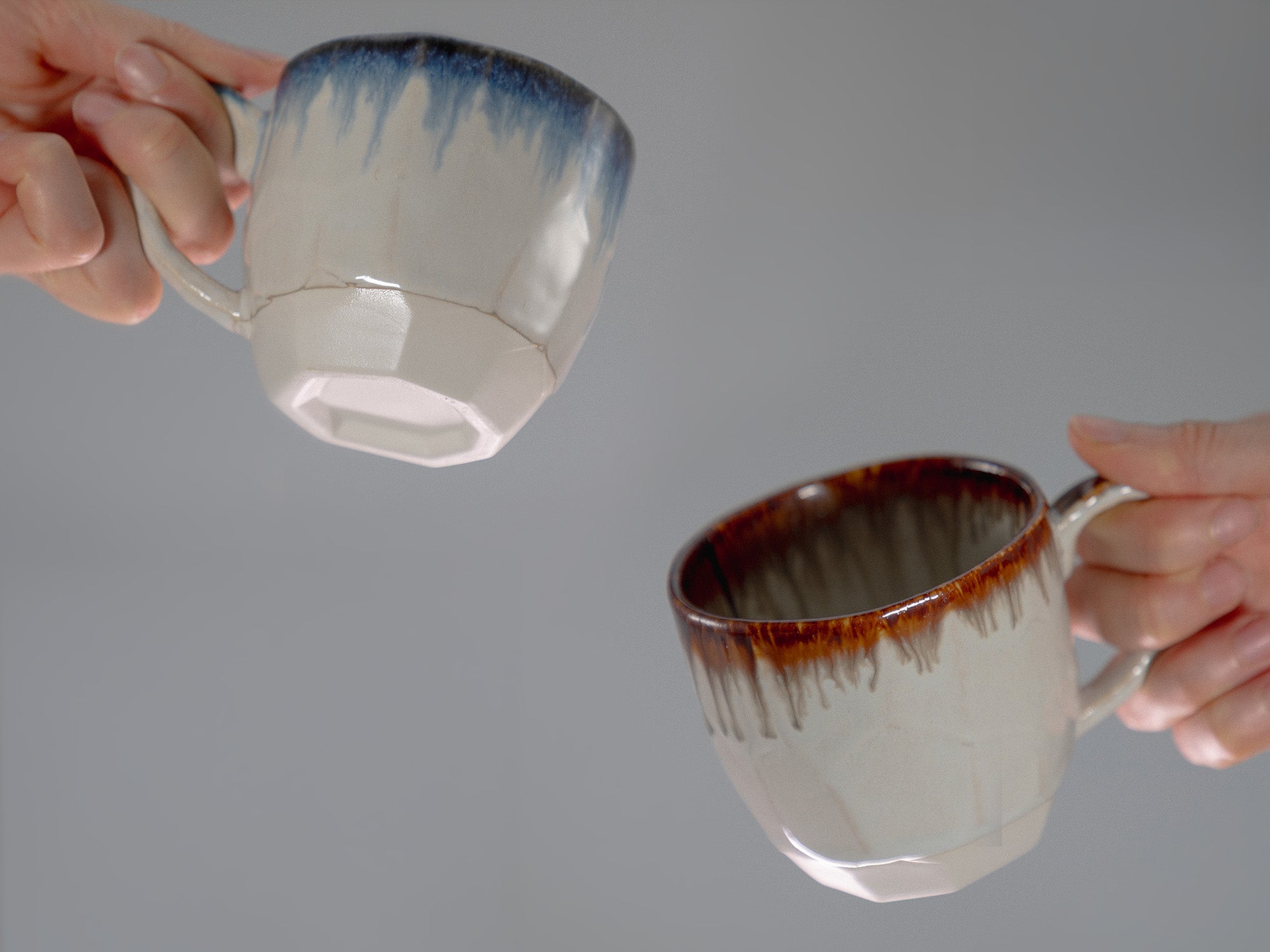 two hands hilding a cup each