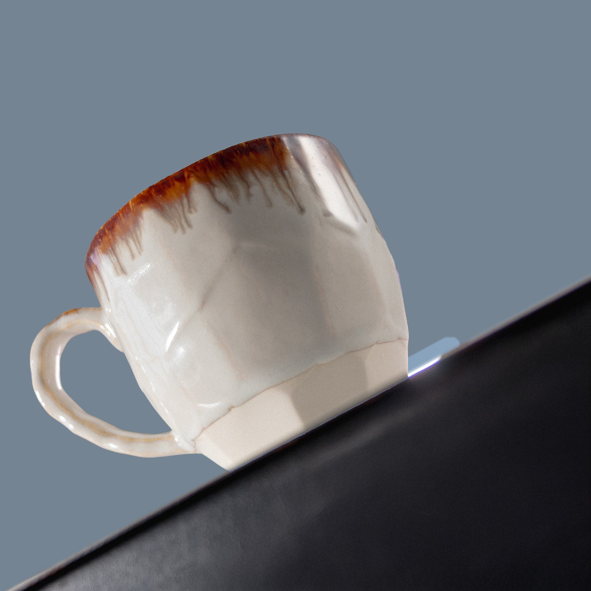 Brown and white cup on a support