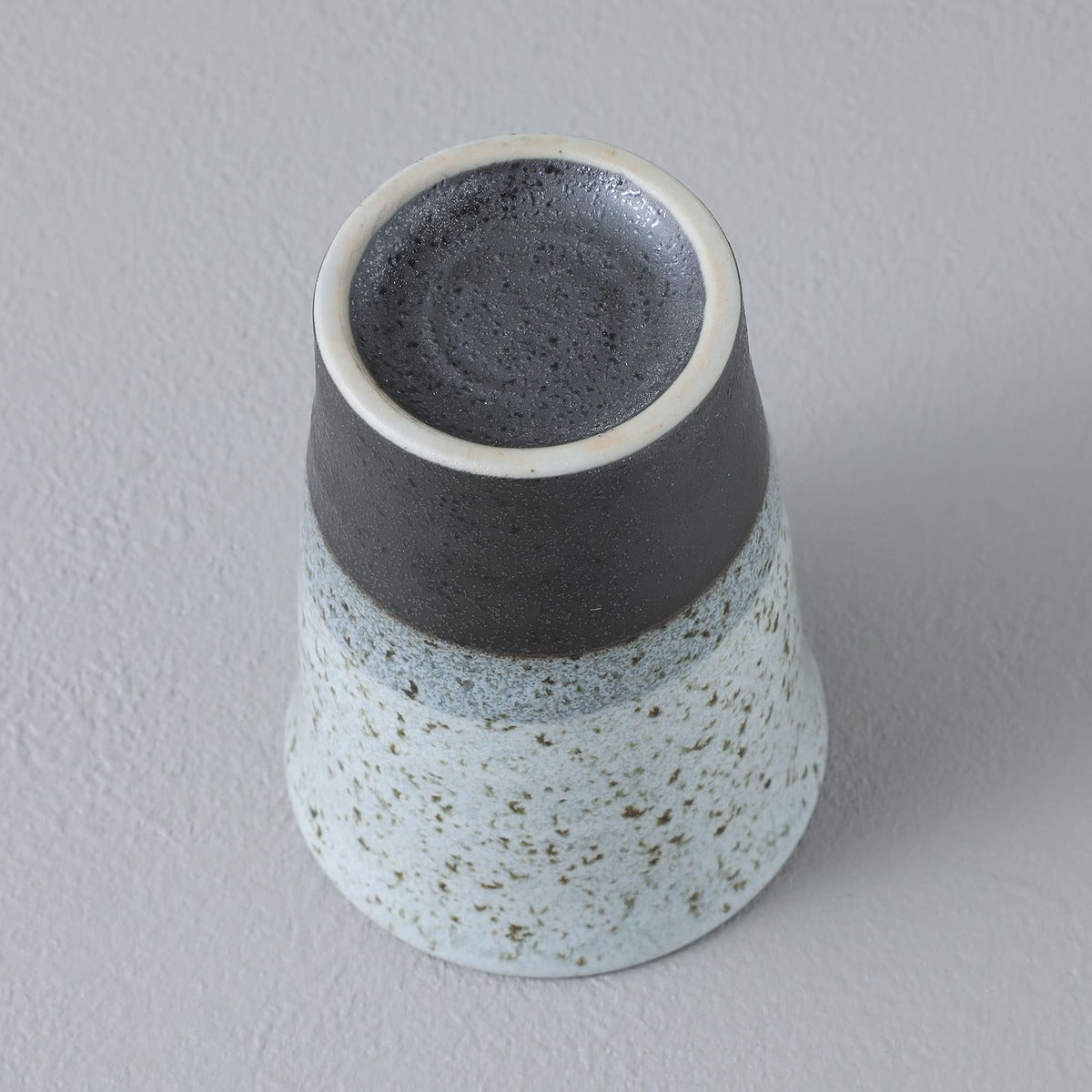 bottom view of a grey ceramic teacup