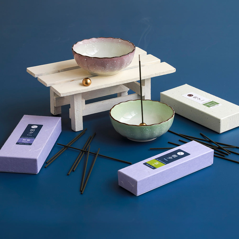 pastel incense holders place aside with incense sticks and boxes