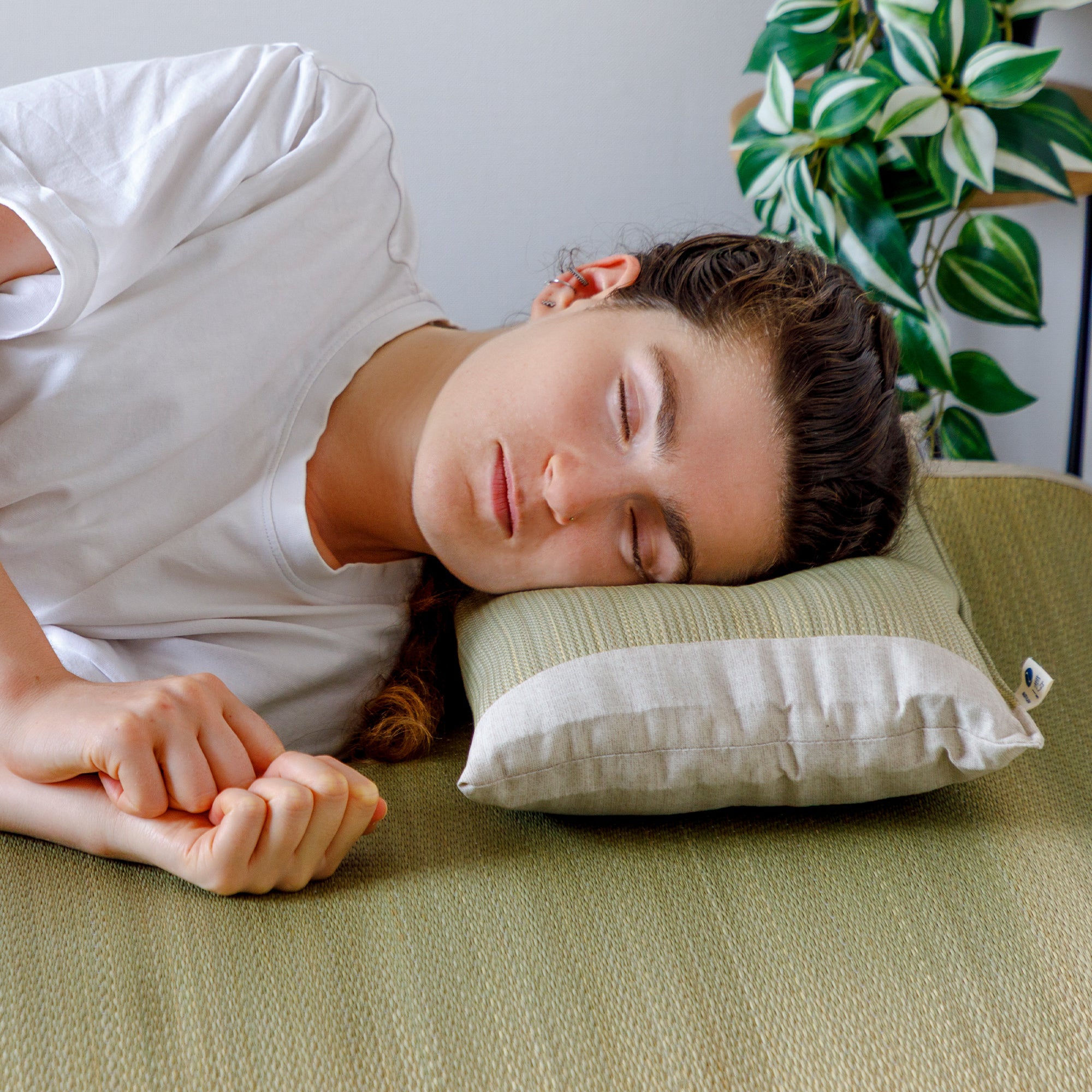 Someone sleeping on a Japanese Igusa Flat Pillow Beige