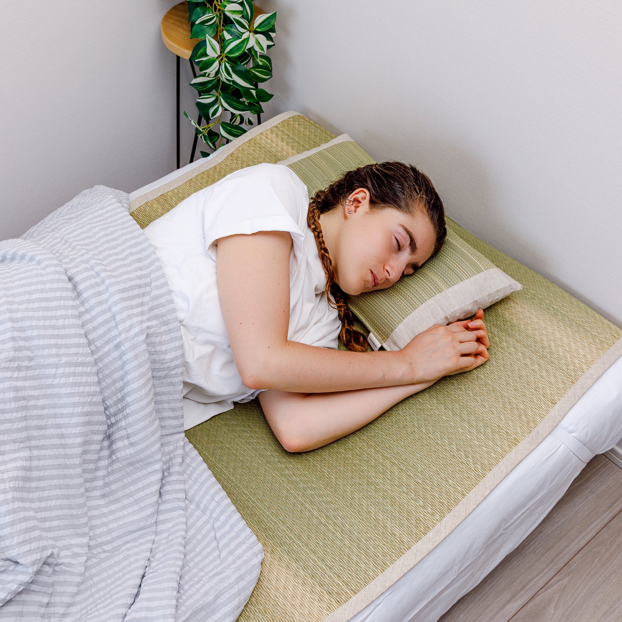 Someone sleeping on a Japanese Igusa Flat Pillow Beige