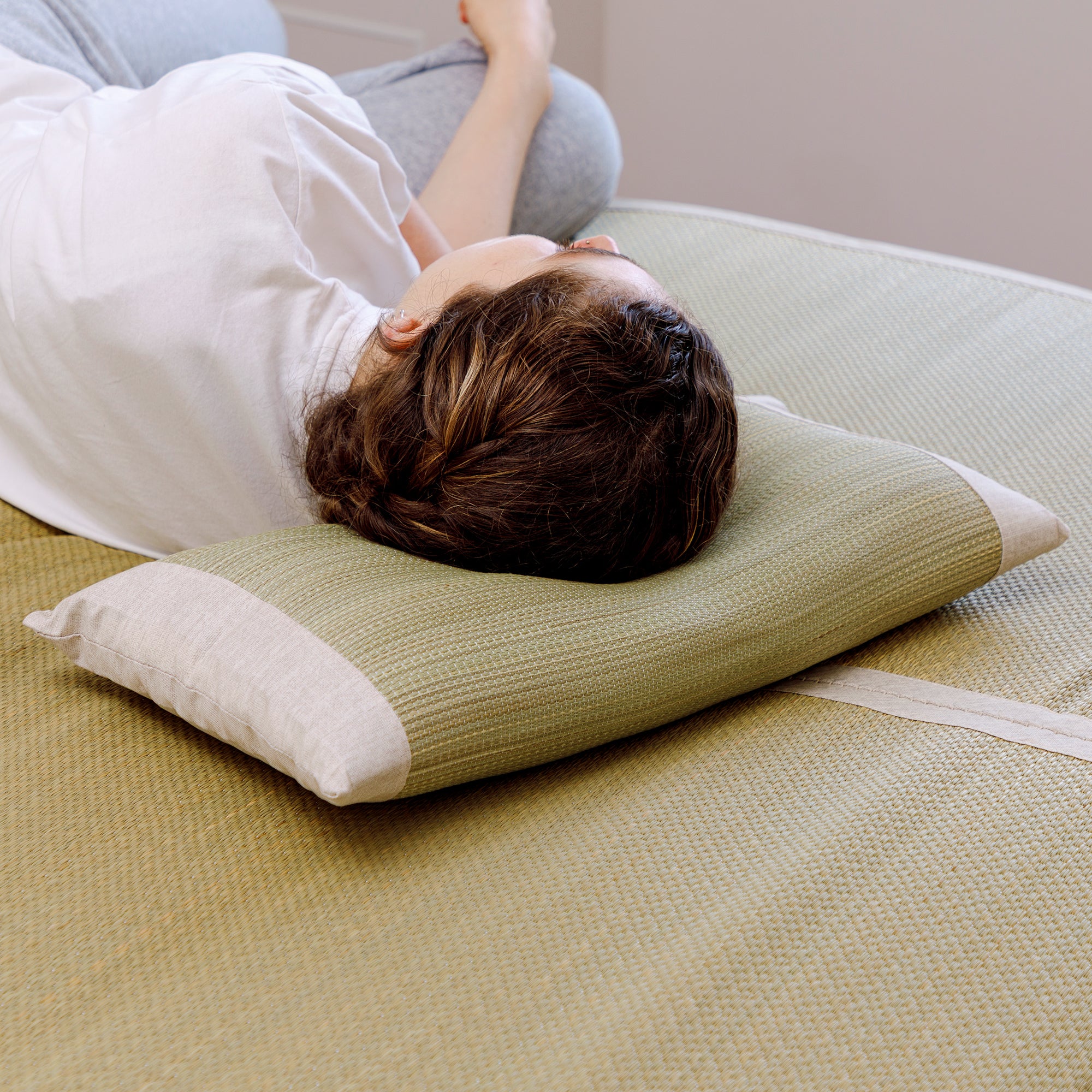Someone sleeping on a Japanese Igusa Flat Pillow Beige