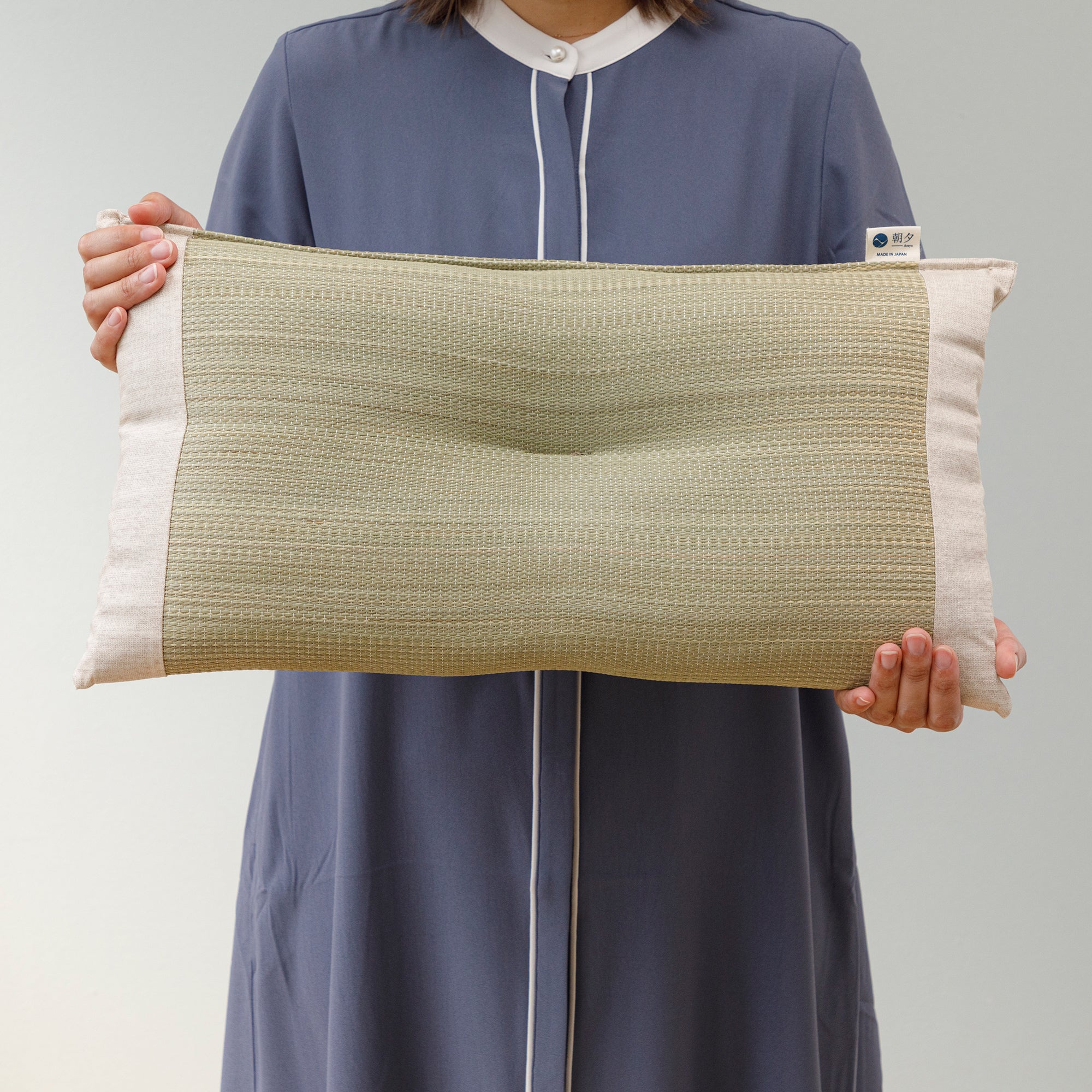 Someone holding a Japanese Igusa Flat Pillow Beige