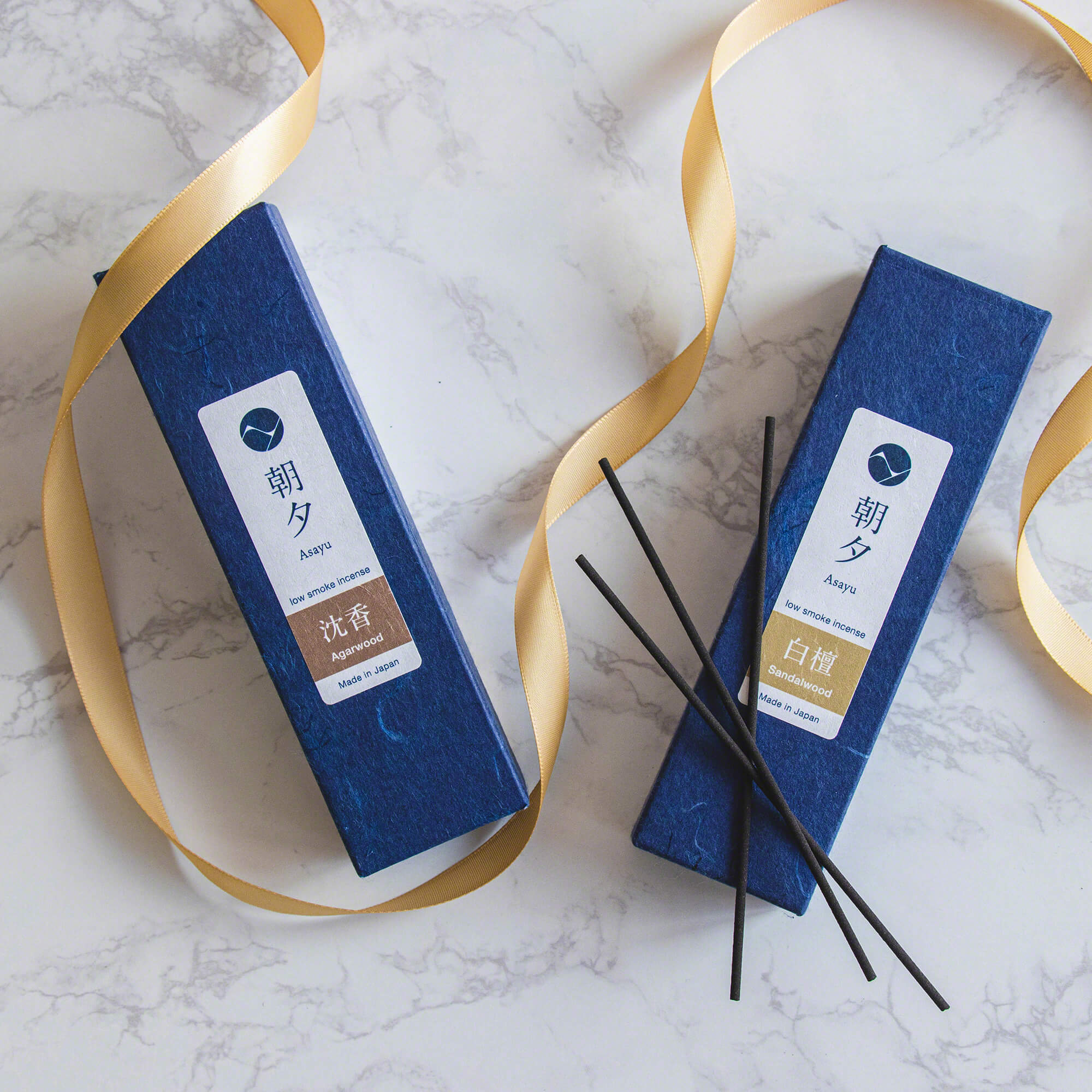 a box of agarwood incense next to a box of sandalwood incense