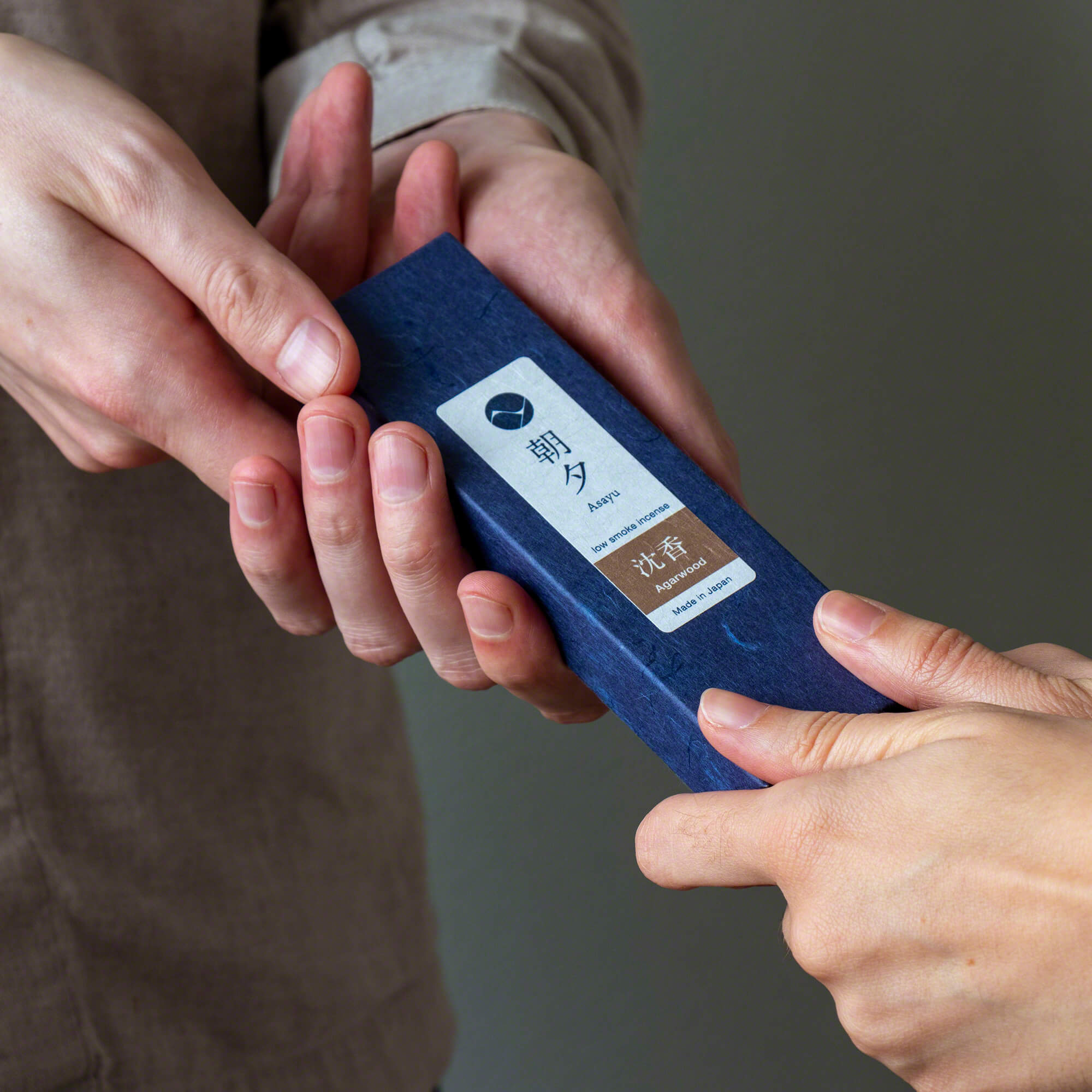 someone gifting a box of agarwood incense