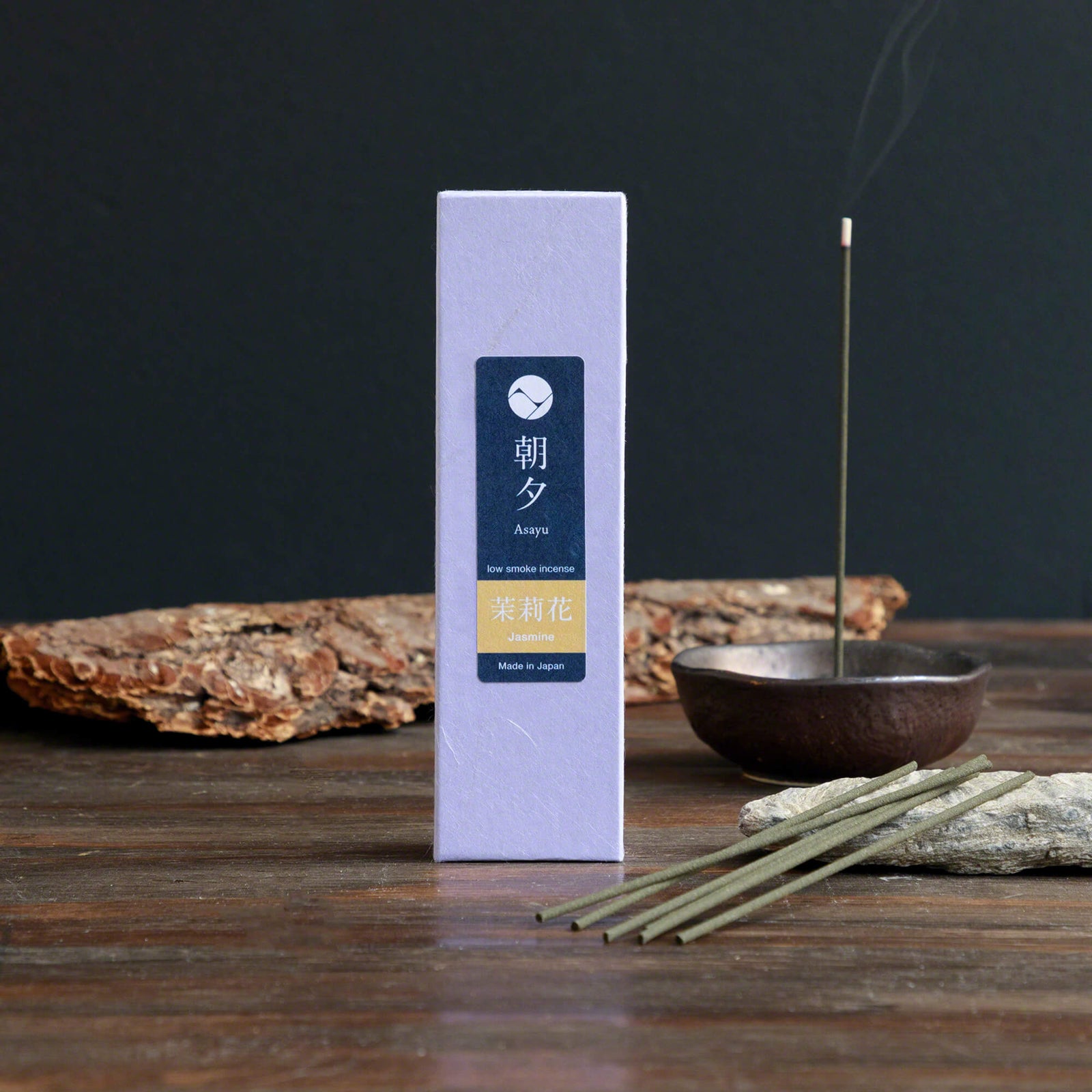 20g Box of jasmine incense sticks in display with a piece of wood bark and incense holder