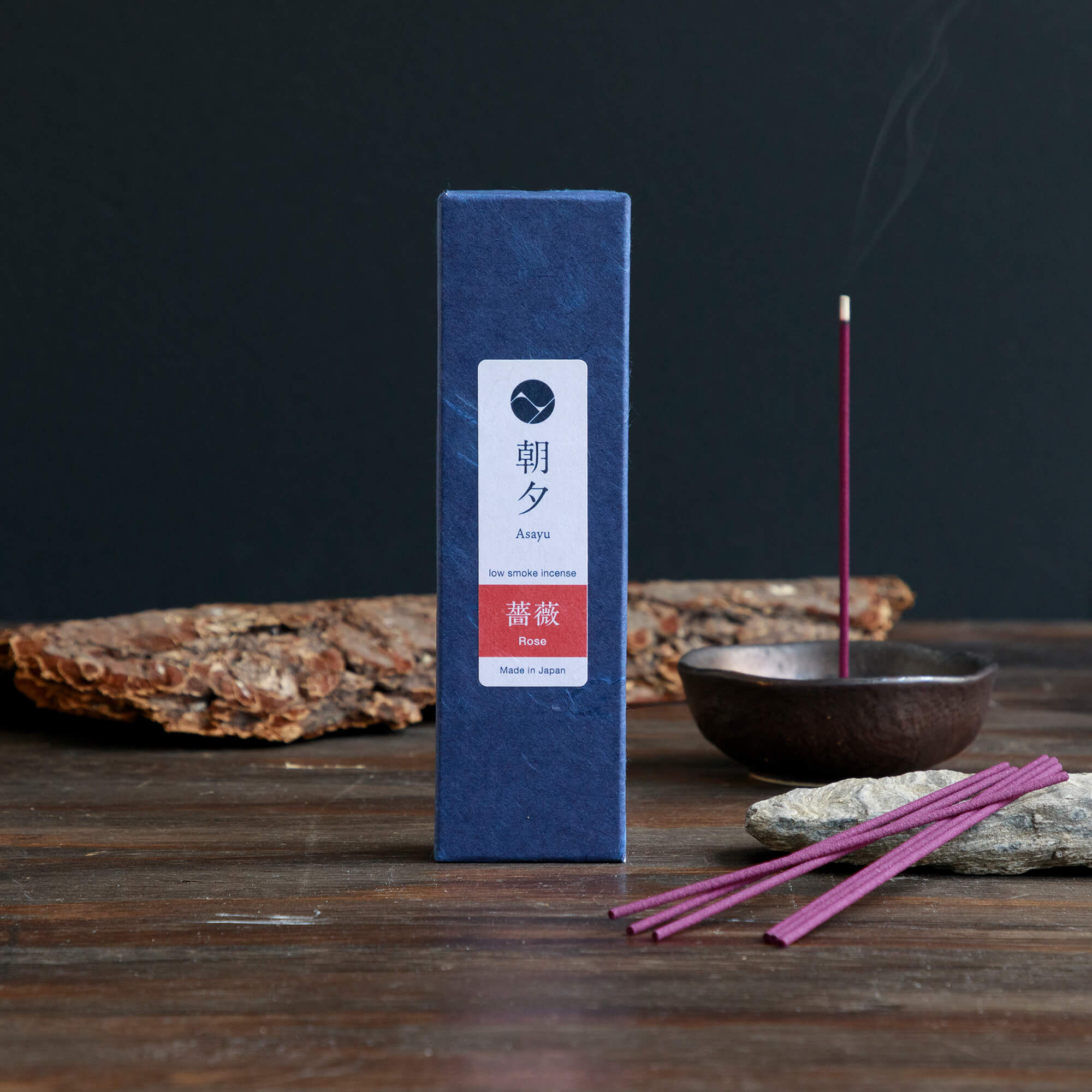 20g Box of rose incense sticks opened in display with a piece of wood bark and an incense holder