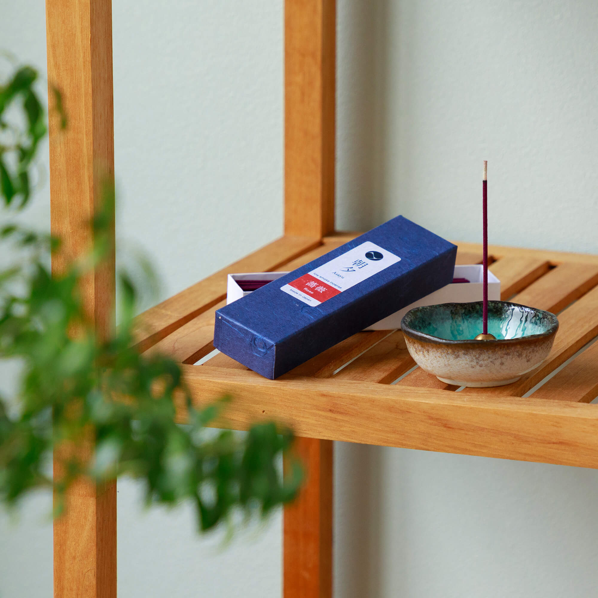 20g Box of rose incense sticks opened in display with a small incense holder on a shelf