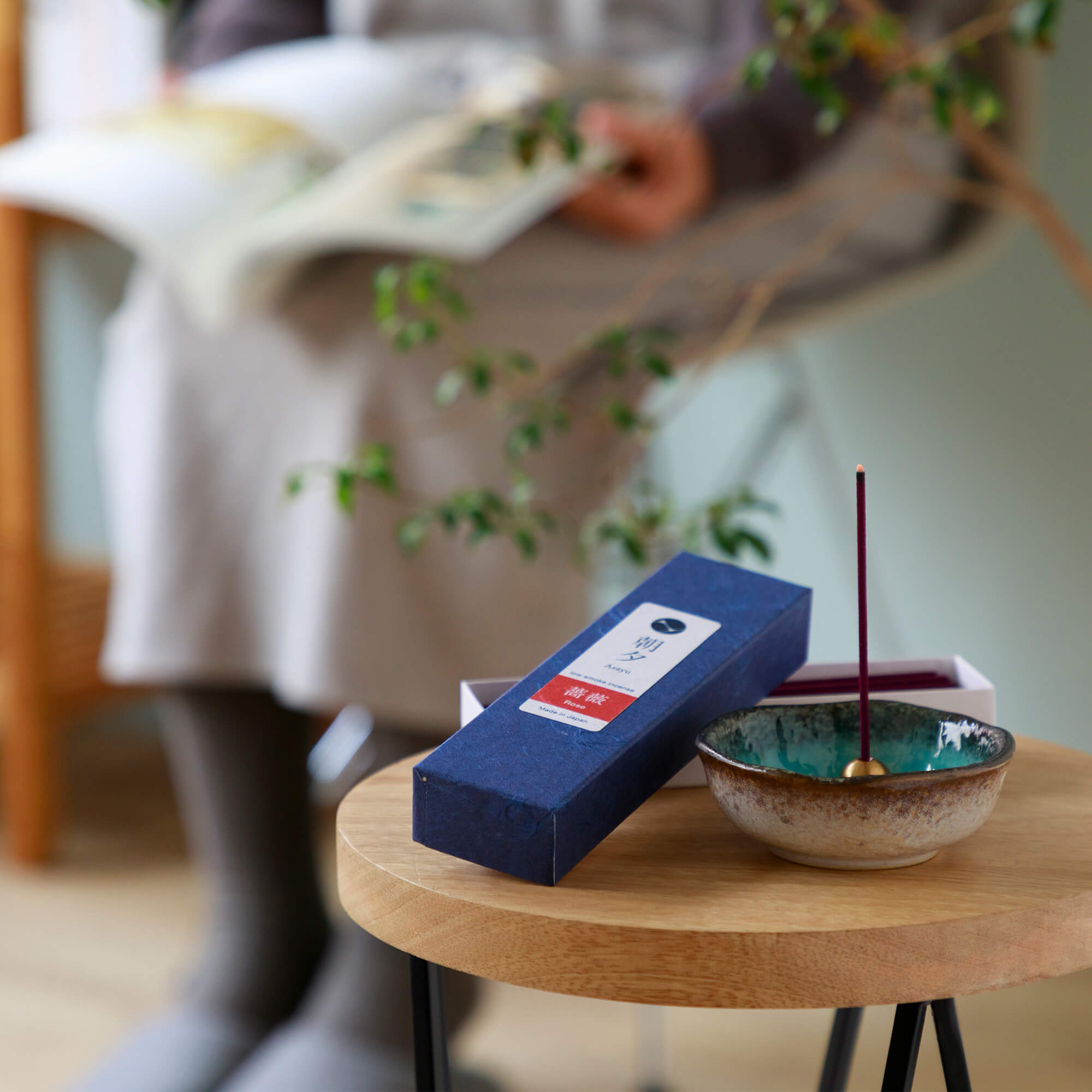 20g Box of rose incense sticks opened in display with an incense holder on a stool