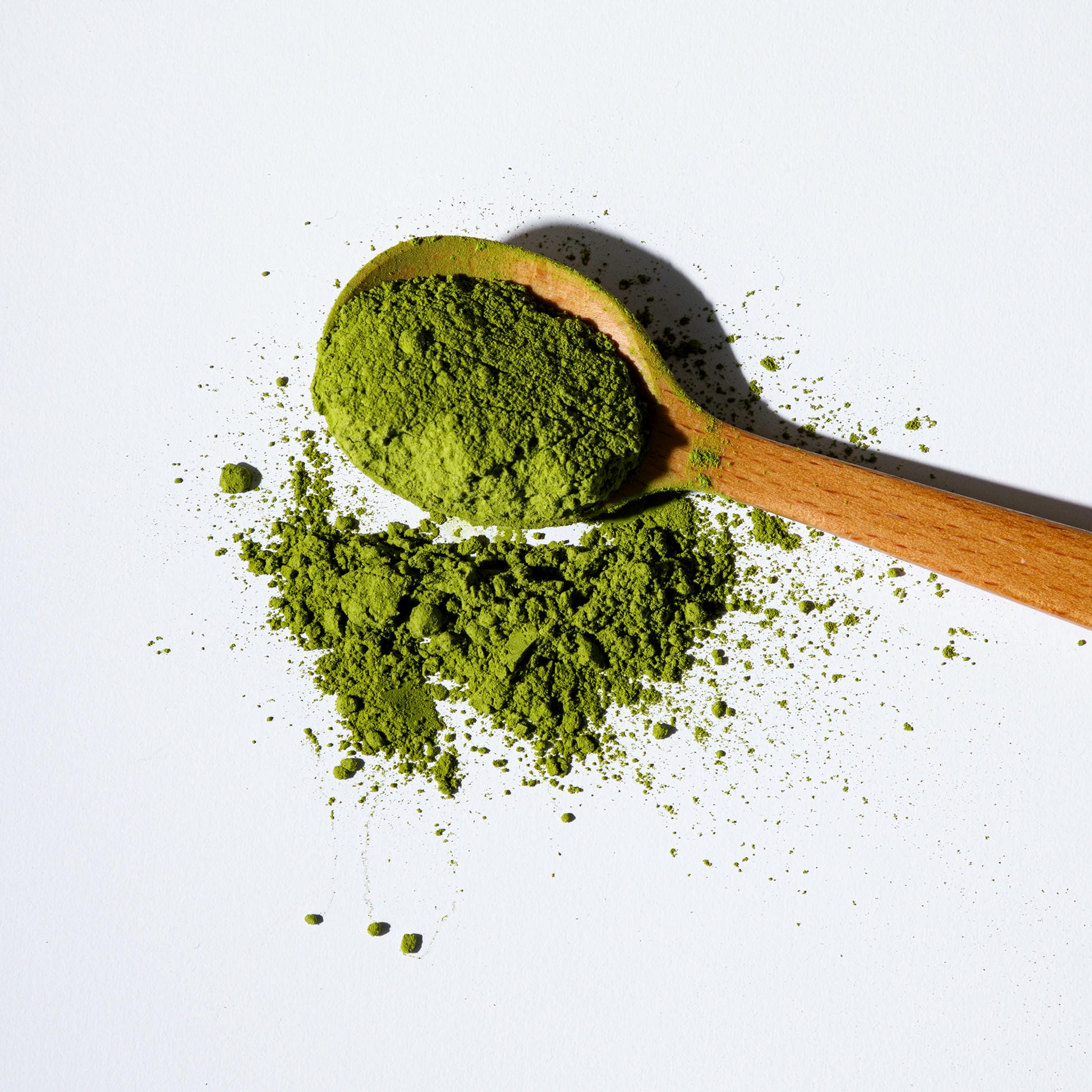 matcha green powder with wooden spoon