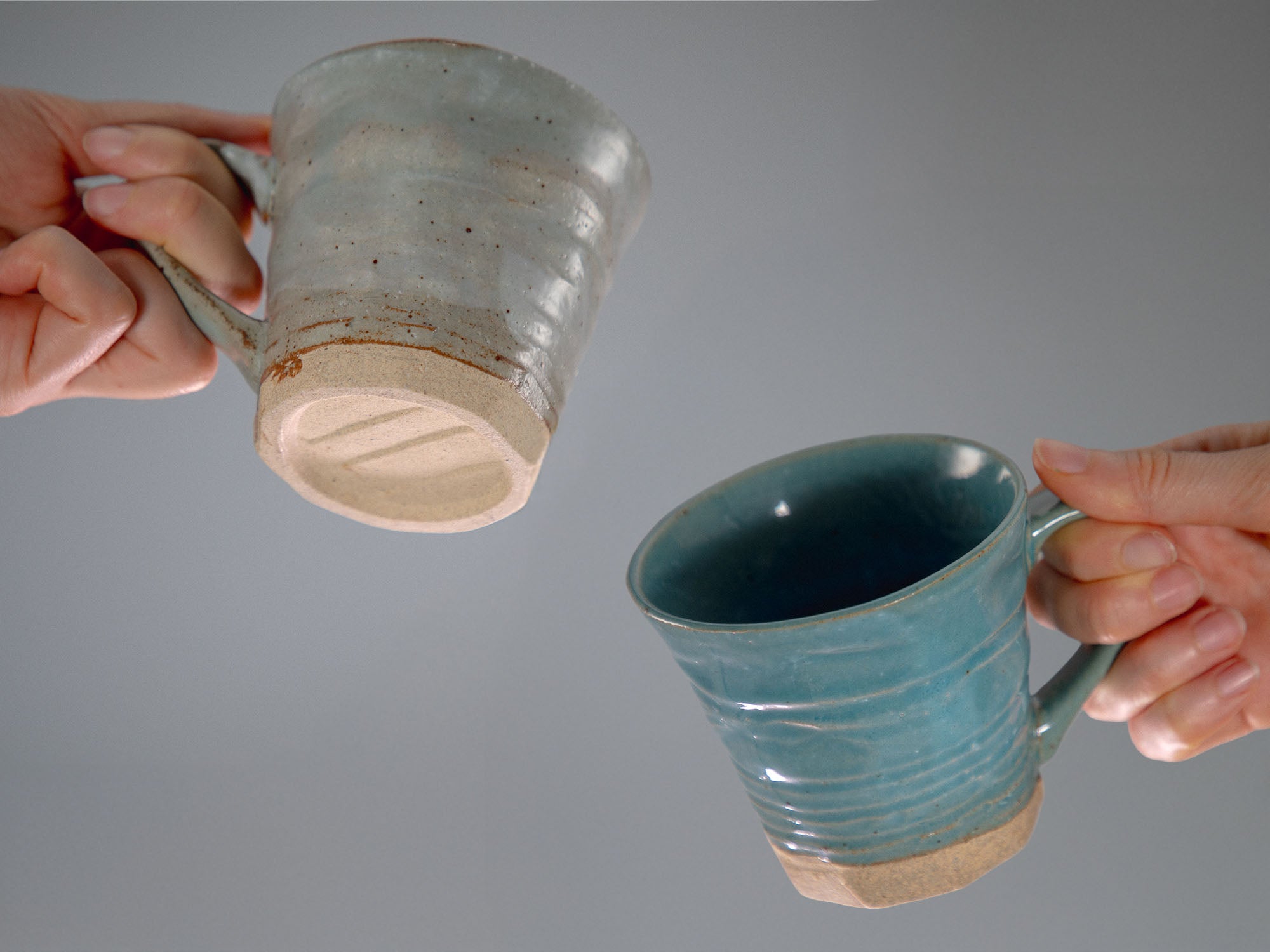 hands holding Tsuchimono Cup Set Blue and Grey