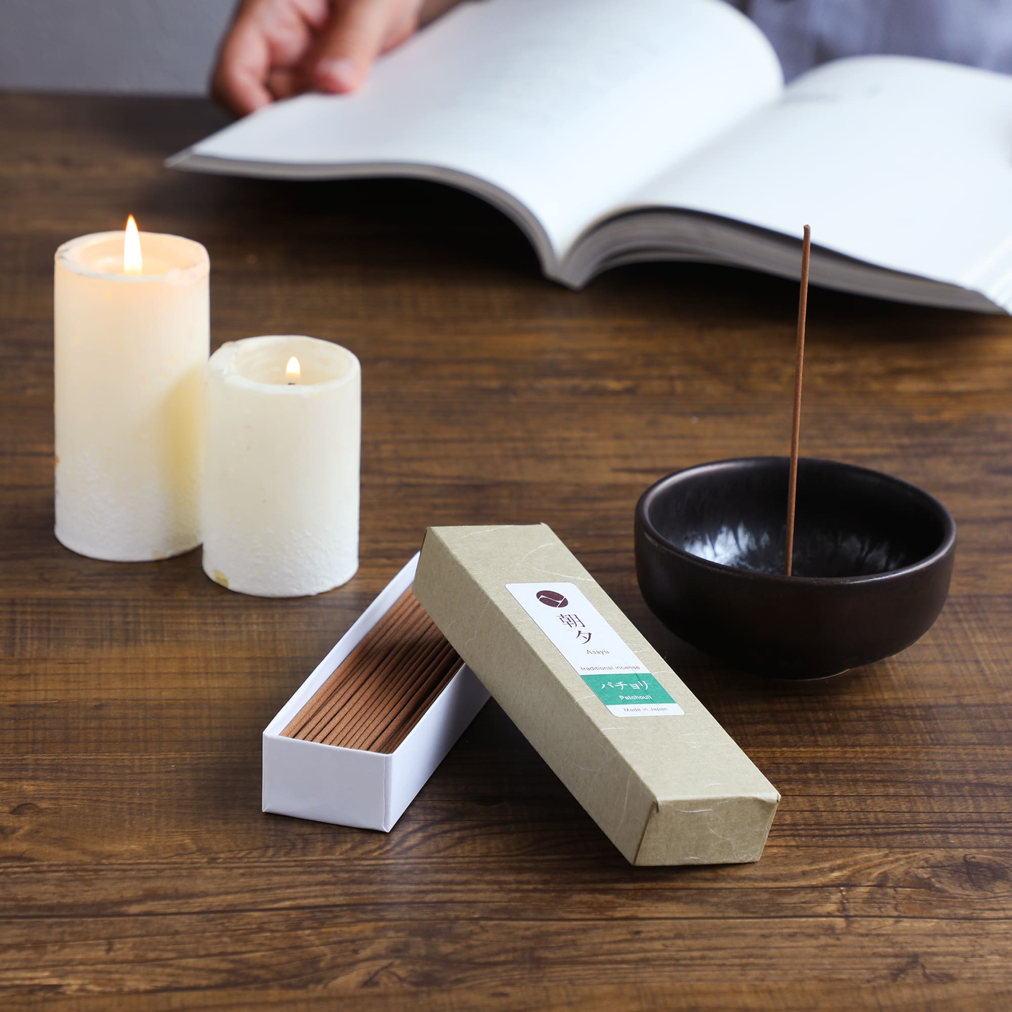 white sage incense next to ceramic holder and candles