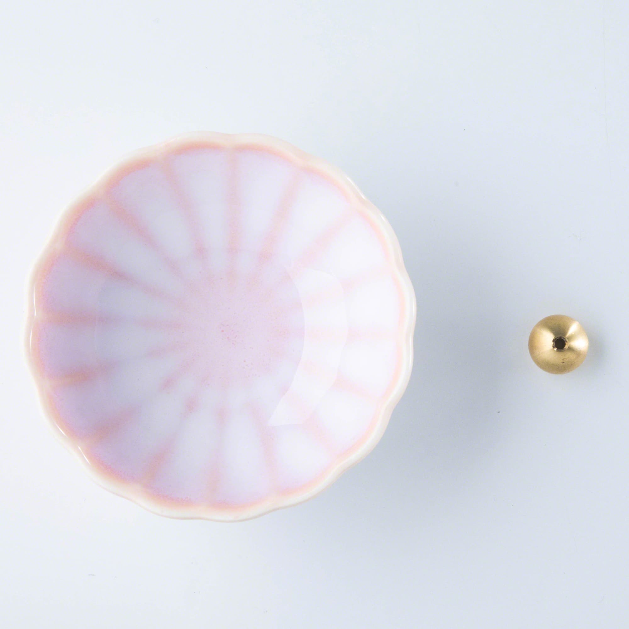 Asayu Japan Cherry Blossom Pink ceramic incense plate with included brass incense burner stand next to it from the top.