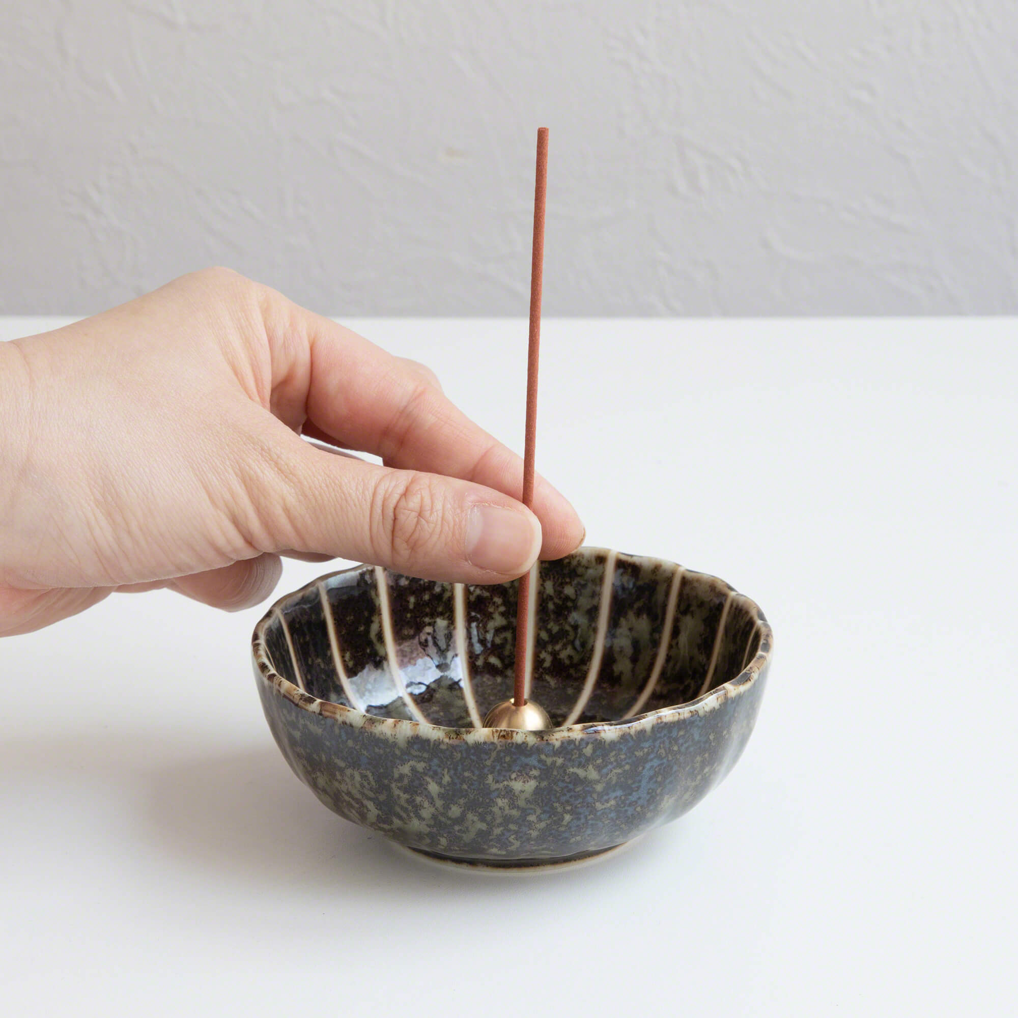 Put the premium aloeswood incense stick in an incense stand over an incense plate or similar surface