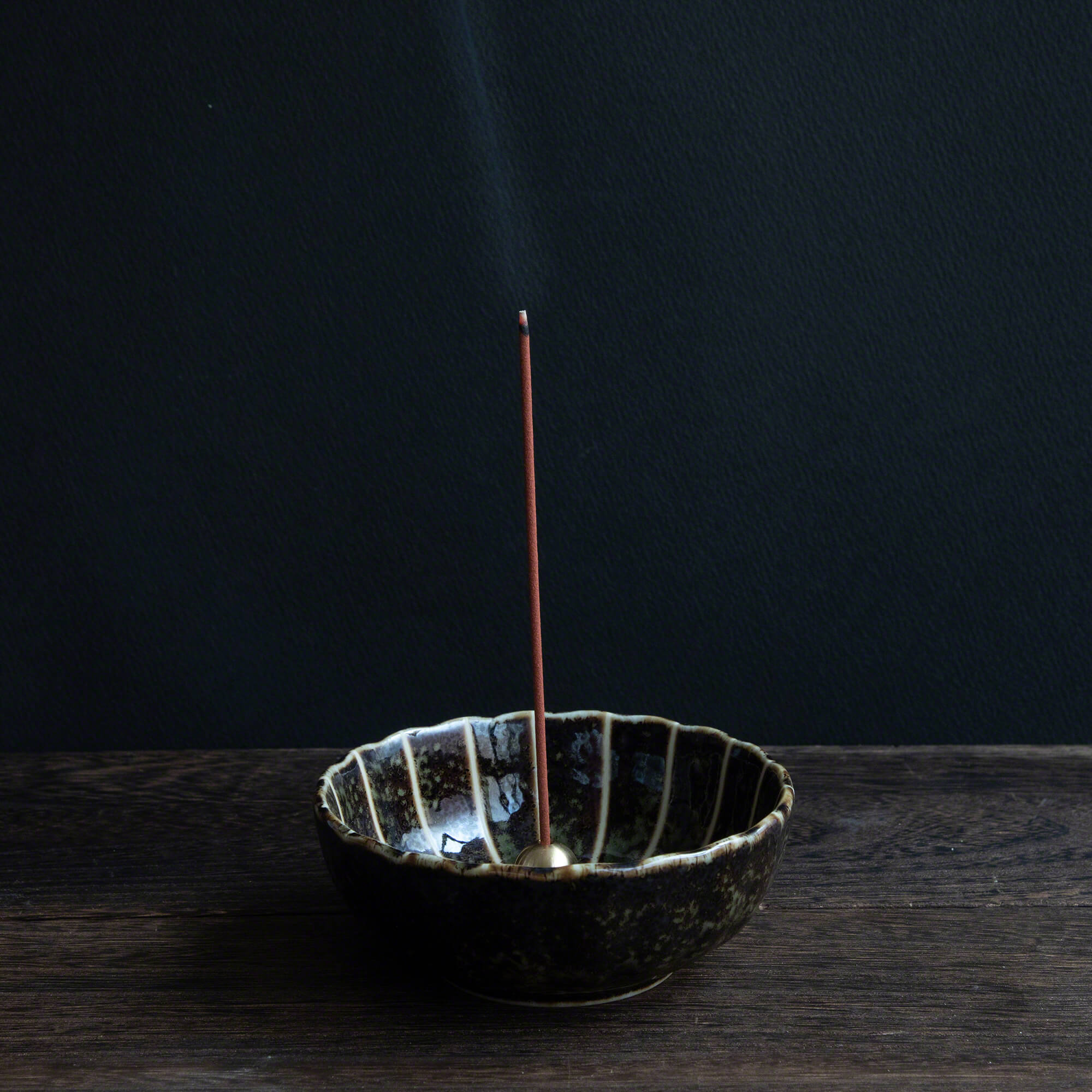 Premium Aloeswood incense sticks burning in an incense holder