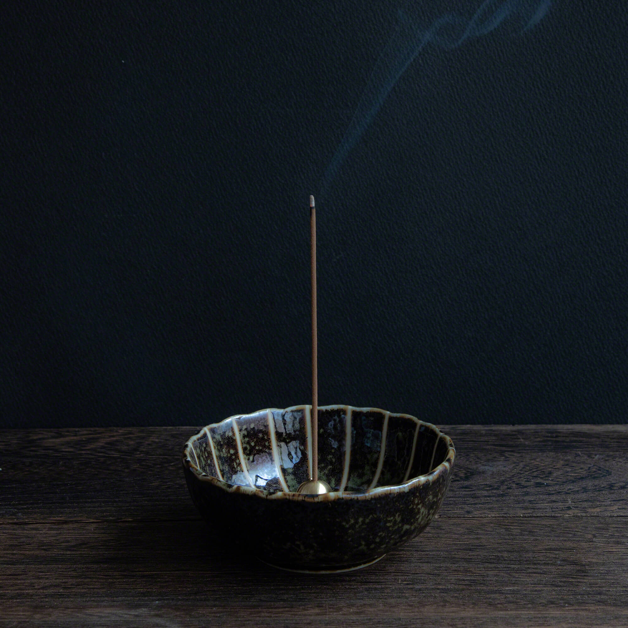 Hinoki Cypress incense sticks burning in an incense holder