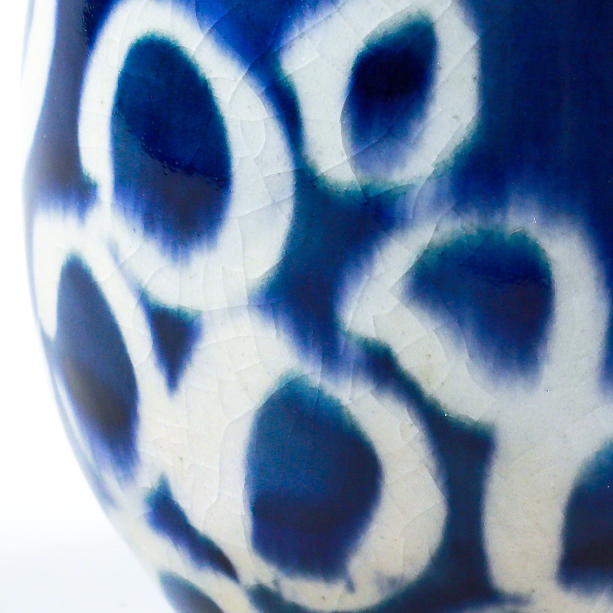 Close-up of the glaze in the Asayu Japan Ceramic Coffee Mug in ocean blue with a white circualr abstract pattern.