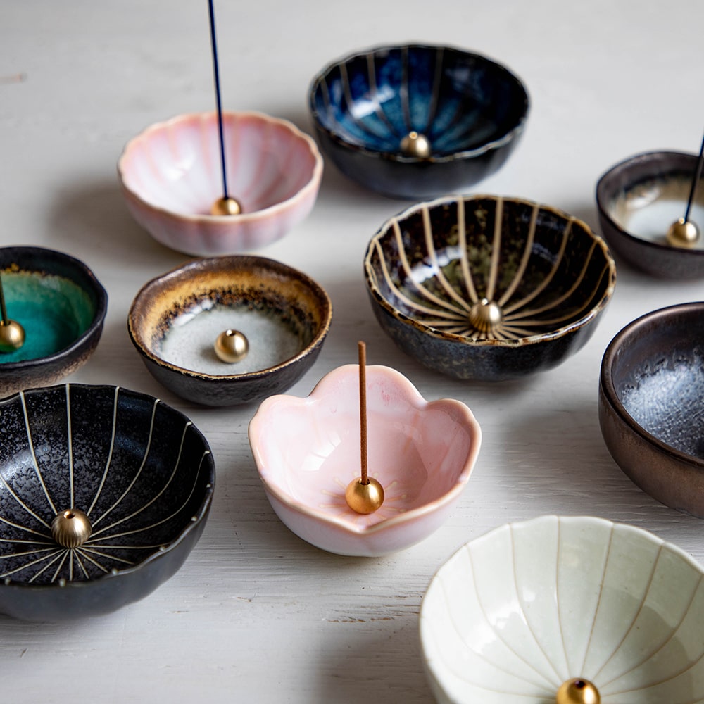 Arrangement of Asayu Japan Incense Hodler Colelction with the Cherry Blossom Mini Lotus Flower model in center with a stick on it.