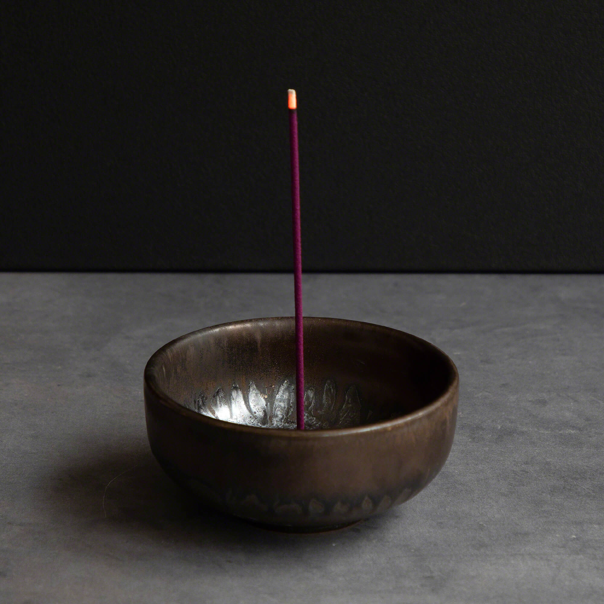 Cherry blossom incense stick burning in an incense holder