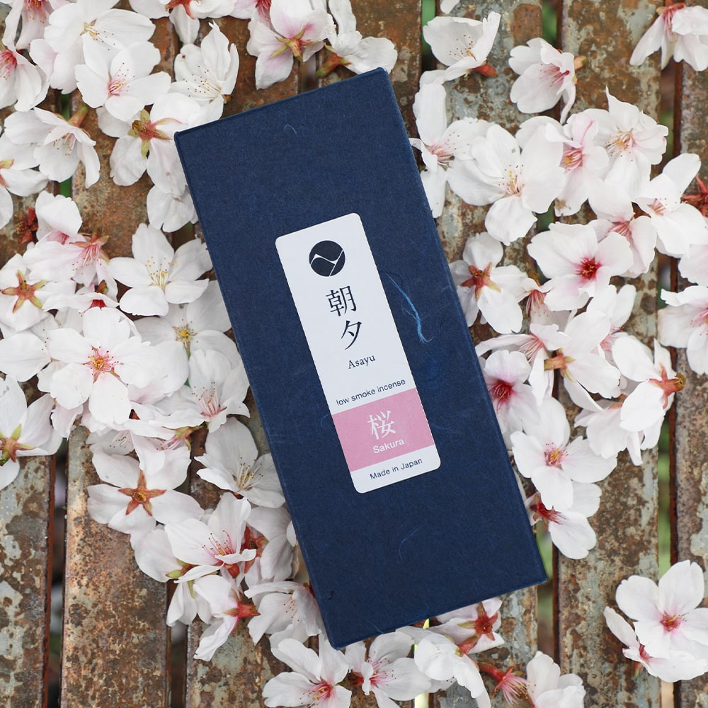 Box of Asayu Japan Sakura Cherry Blossom Low Smoke Incense Sticks surrounded by sakura petals.