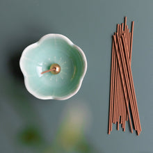 Load image into Gallery viewer, Natural white sage traditional smoke incense sticks by Asayu Japan next to a turquoise mini sakura flower incense holder.
