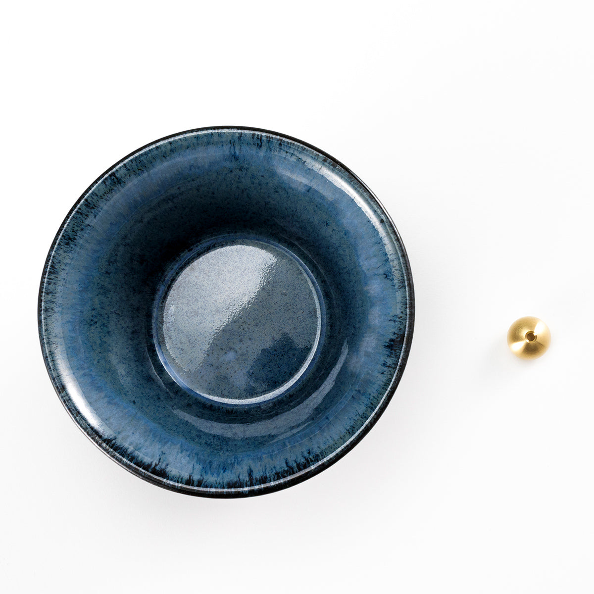 cone shaped blue and black incense holder with brass holder