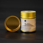 Gold canister of Mt. Fuji Matcha on a black background