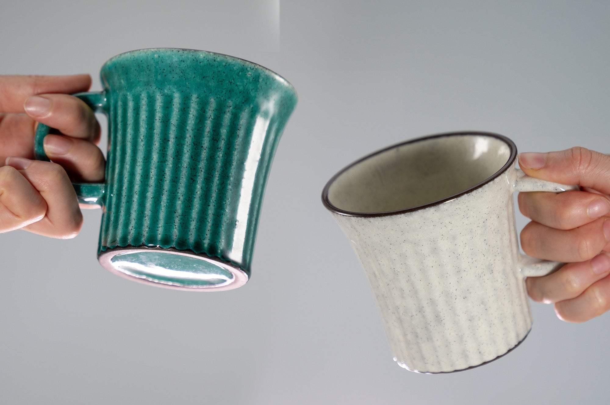 hands holding kairagi ceramic tea cups