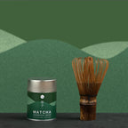 Matcha canister and whisk on a green background