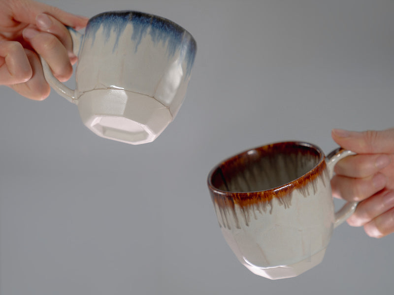 two hands hilding a cup each