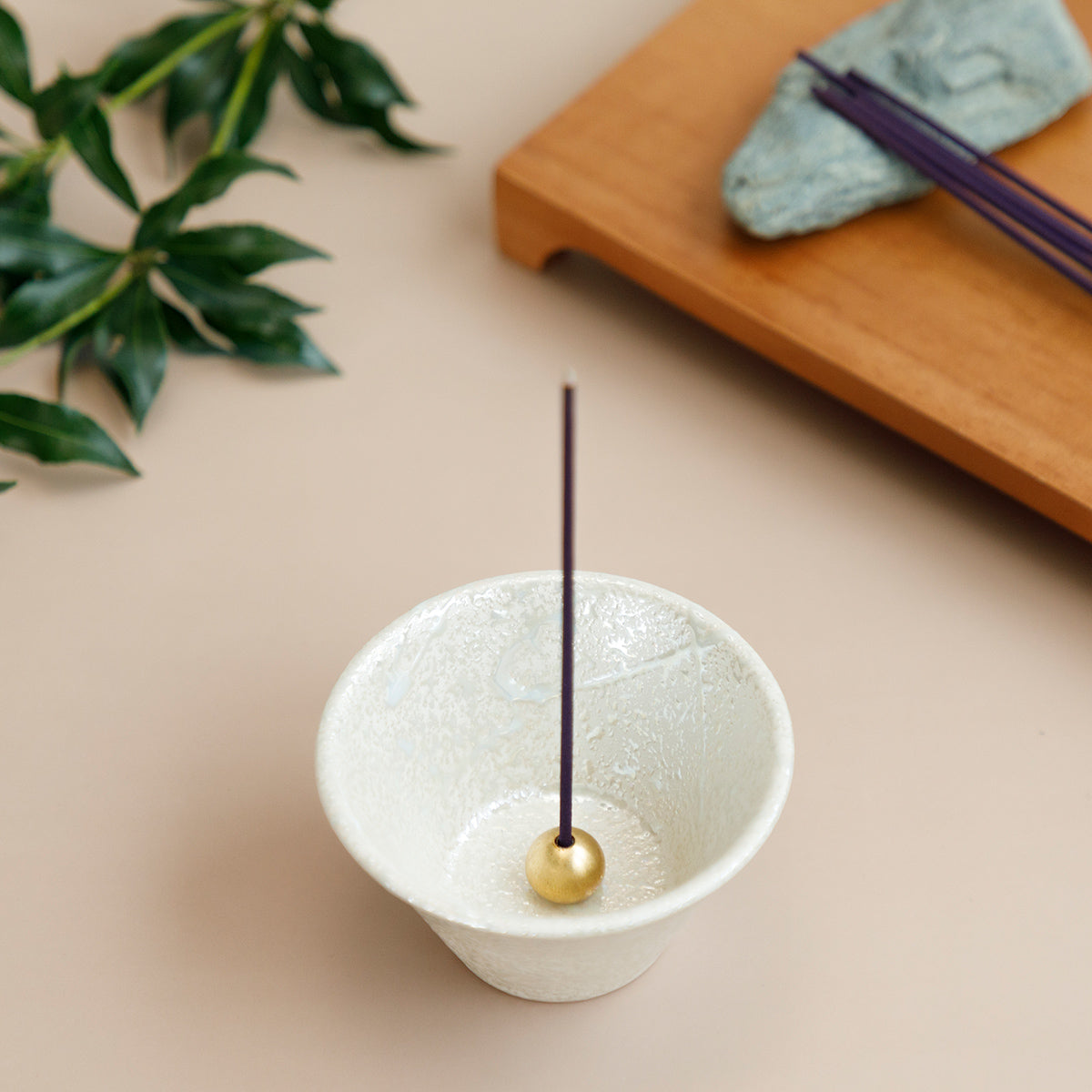 Cone shaped white incense holder with incense stick