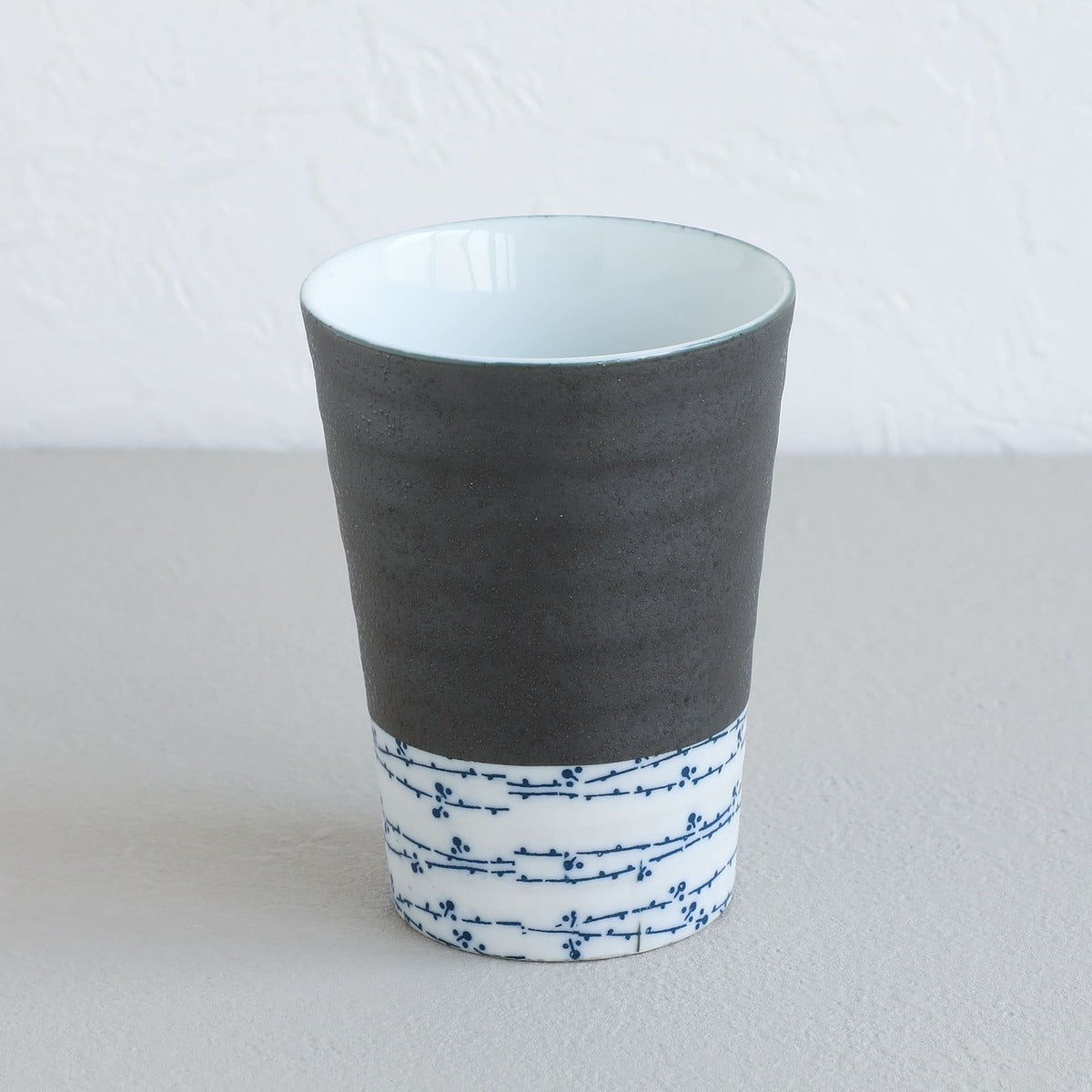 grey and white tea cup