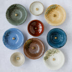 view above several incens holders of different colors