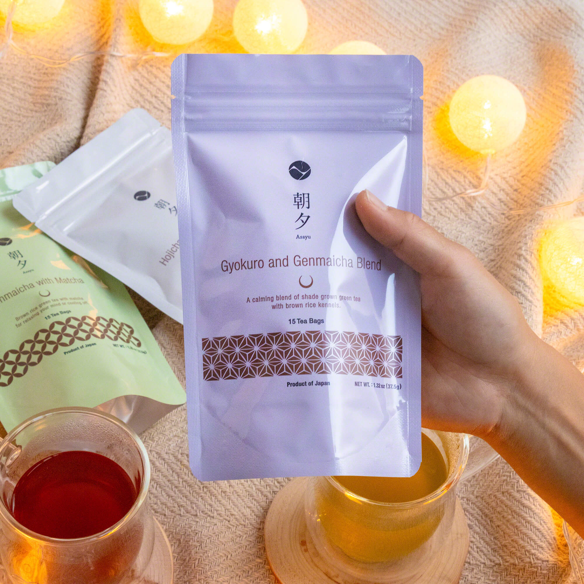hand holding a pouch of asayu gyokuro and genmaicha tea bags