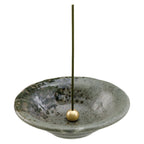 incense stick in green ceramic holder