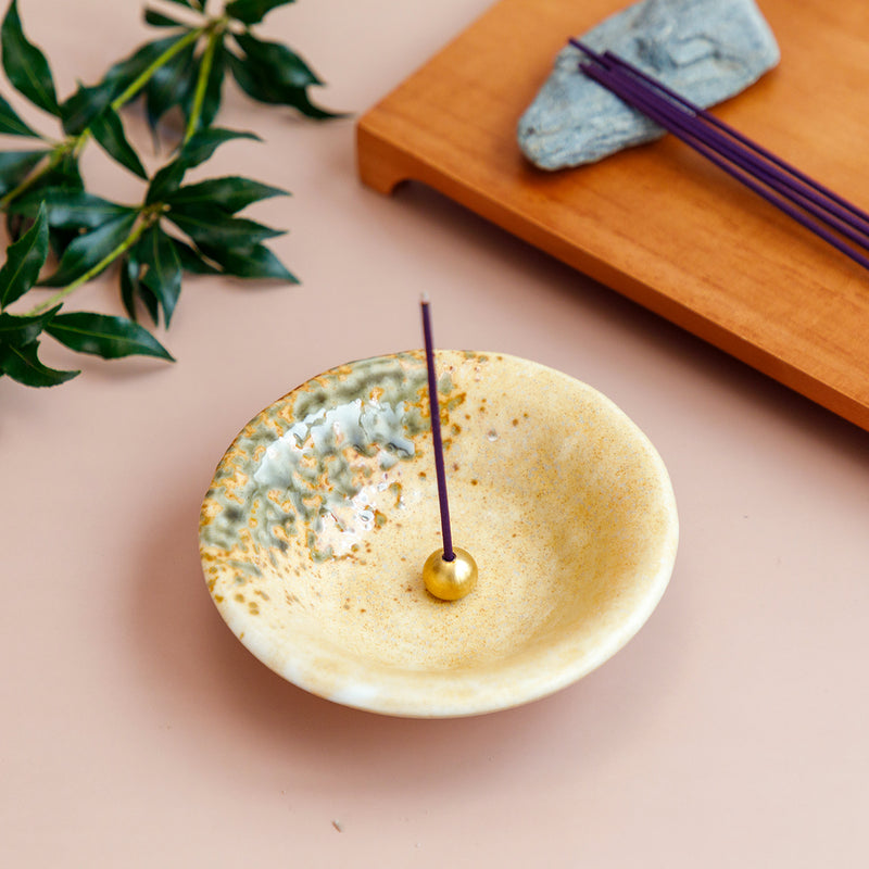 incense in orange ceramic holder