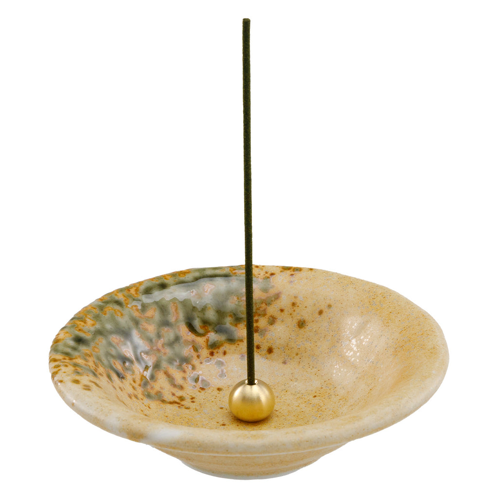 incense stick in orange ceramic holder