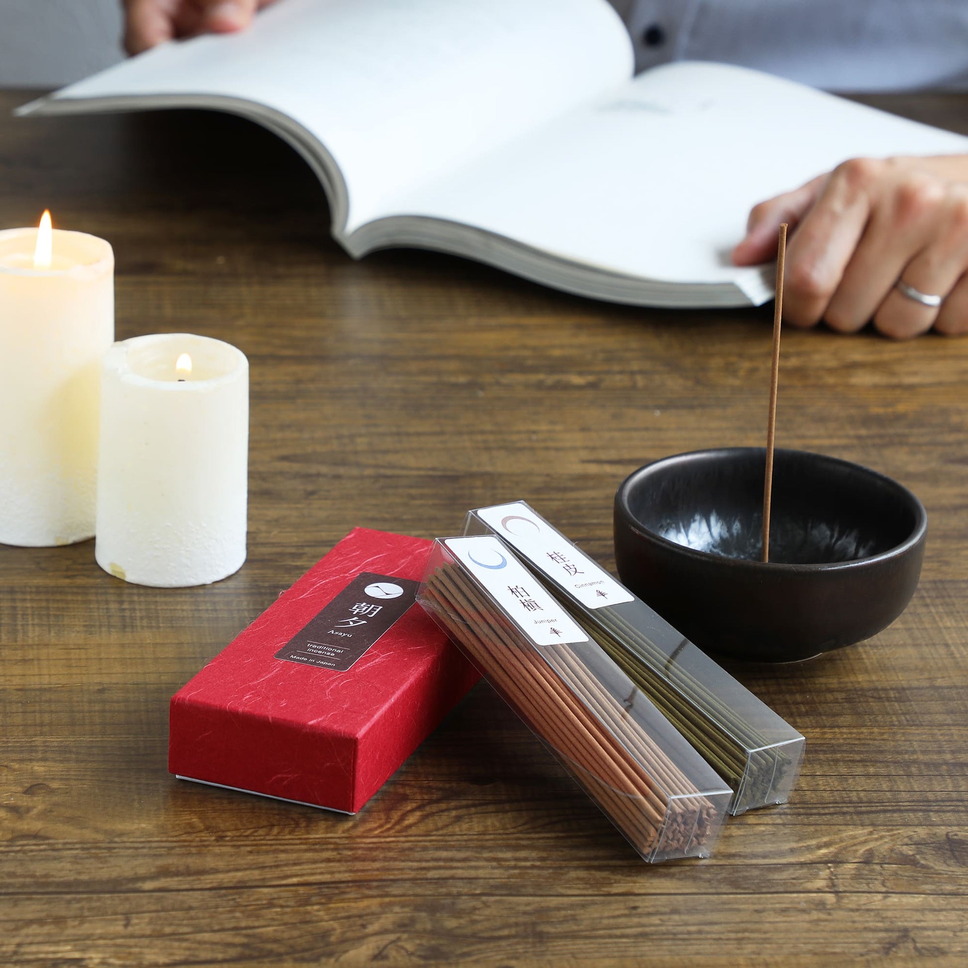 cinnamon and juniper incensebox with incenseholder and candales on a table
