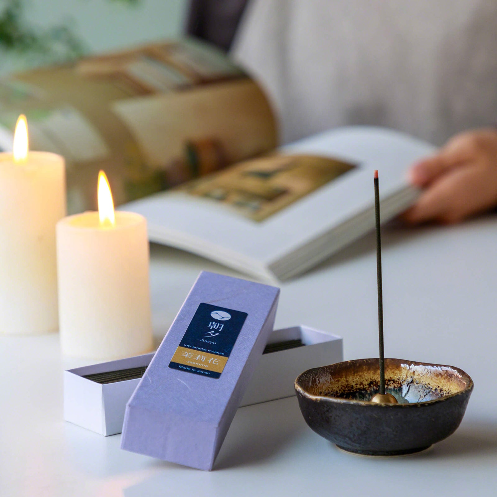 20g Box of jasmine incense sticks in display with small incense holder and candles