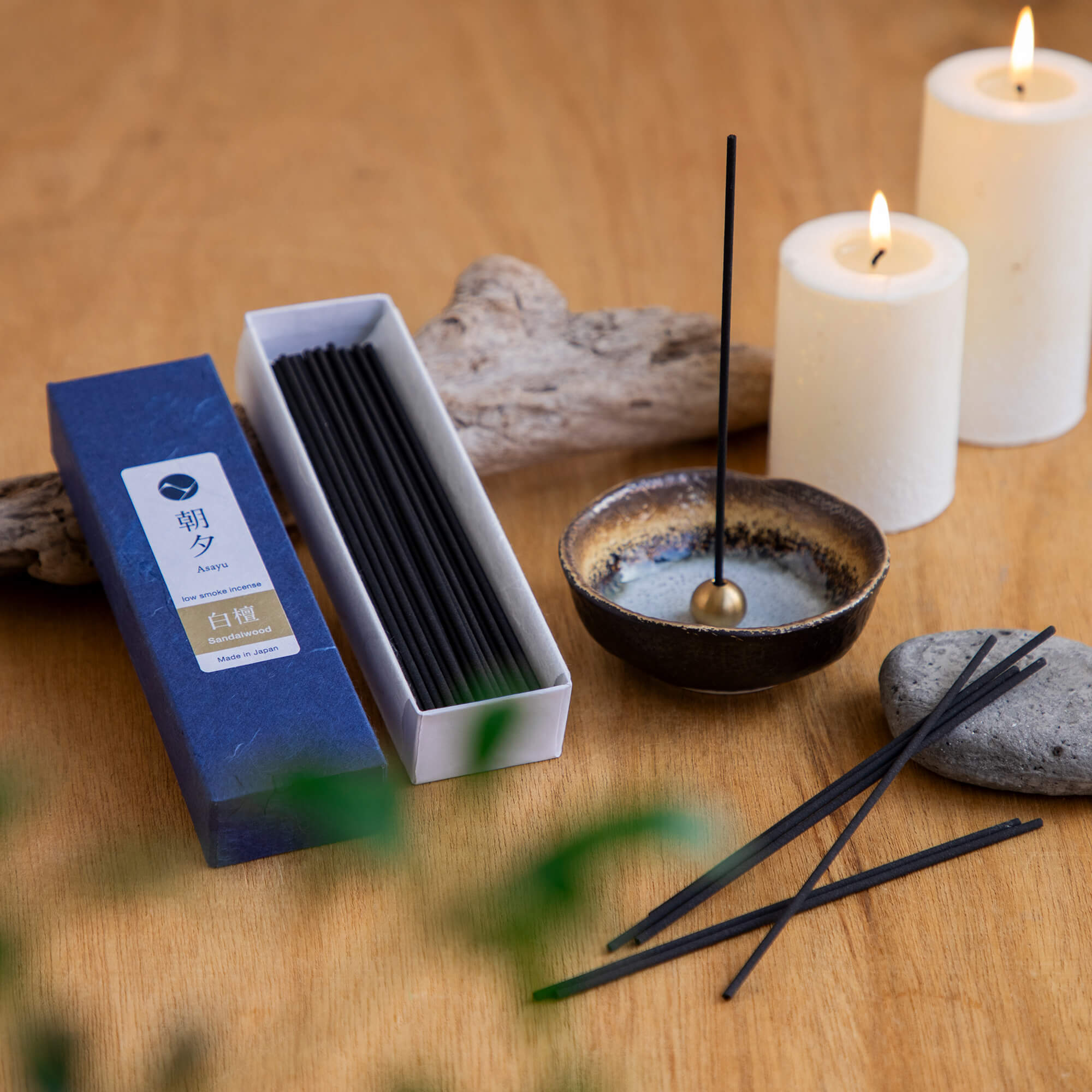 20g Box of sandalwood incense sticks in display with incense holder and candles