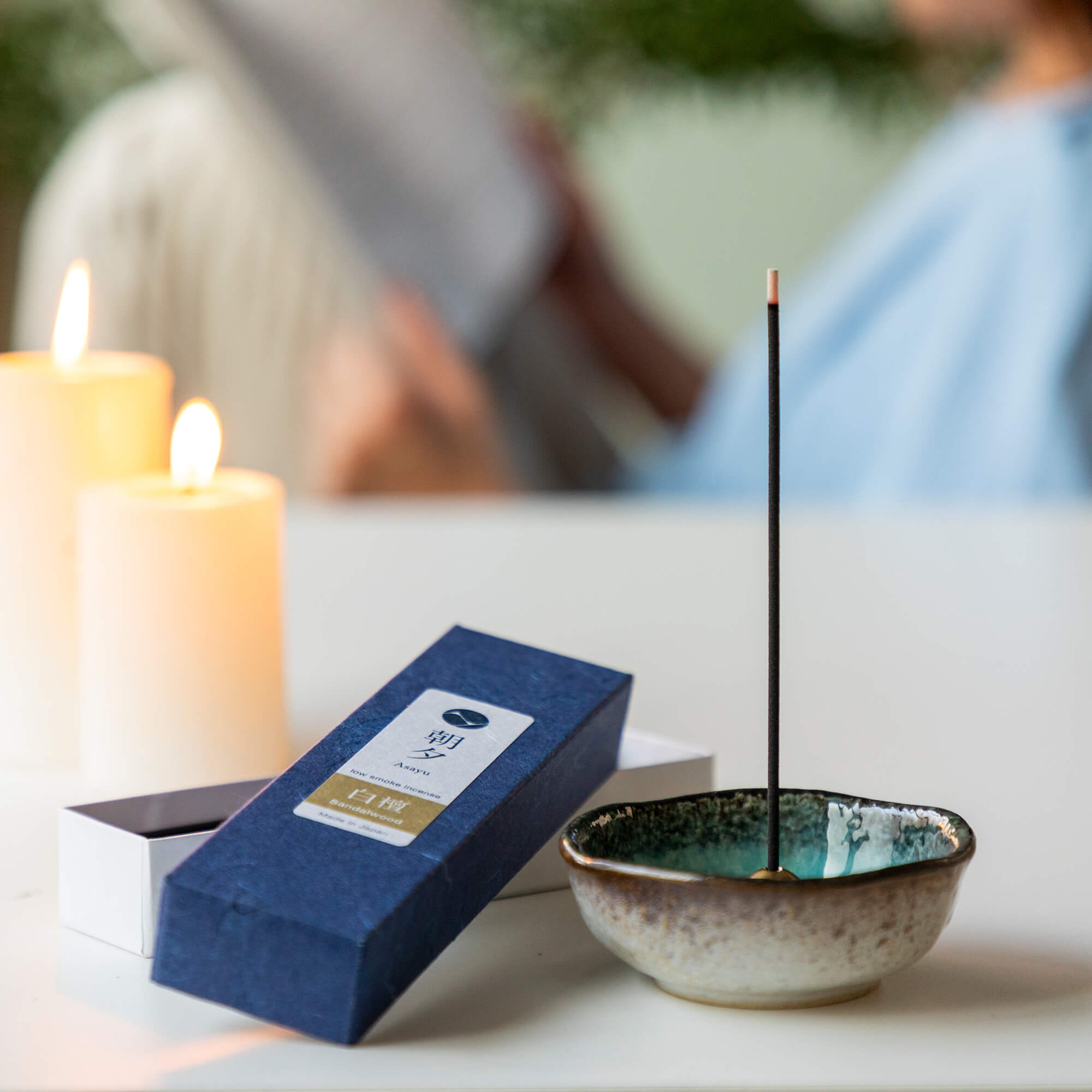 20g Box of sandalwood incense sticks in display with incense holder and candles