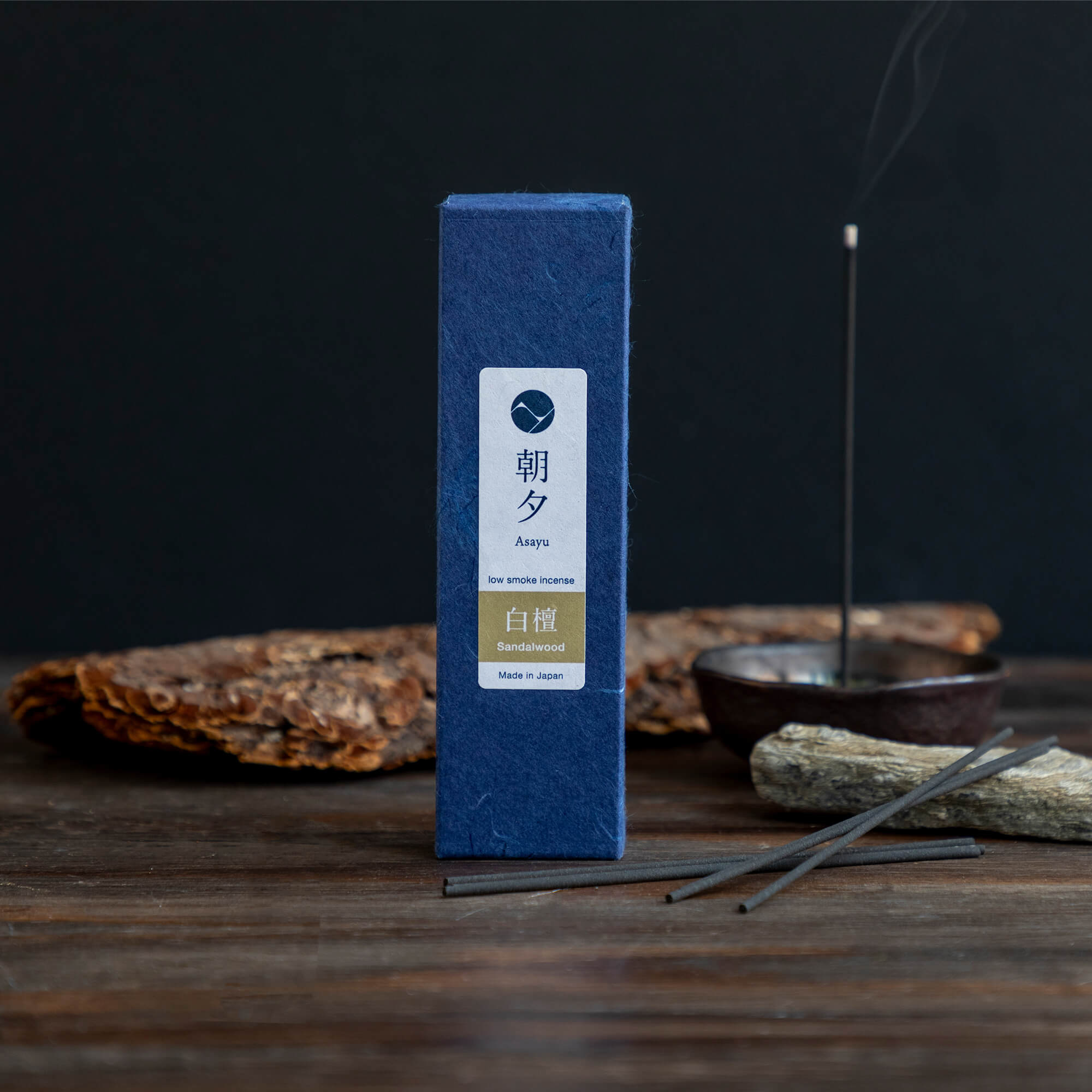 20g Box of sandalwood incense sticks in display with wood bark and incense holder