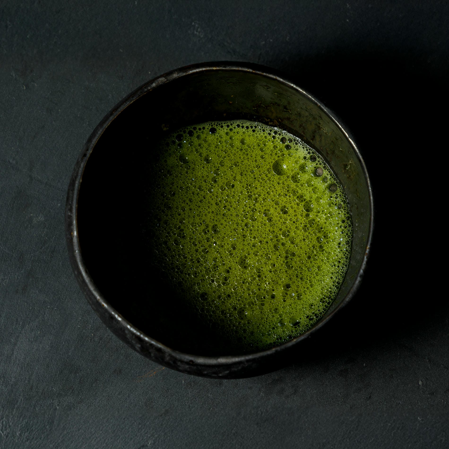 A bowl with matcha tea inside