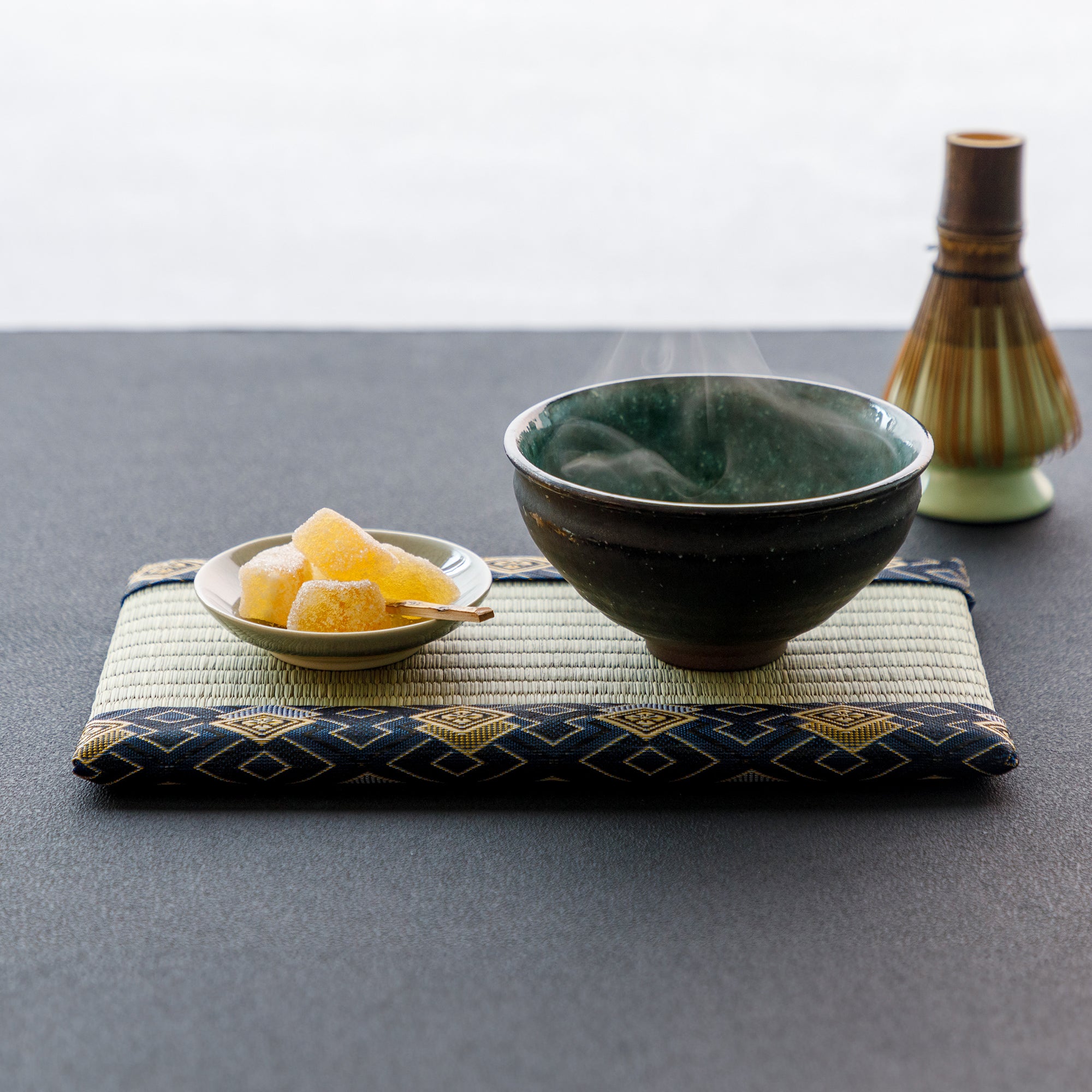 mini tatami with match bowl and japanese sweets on plate