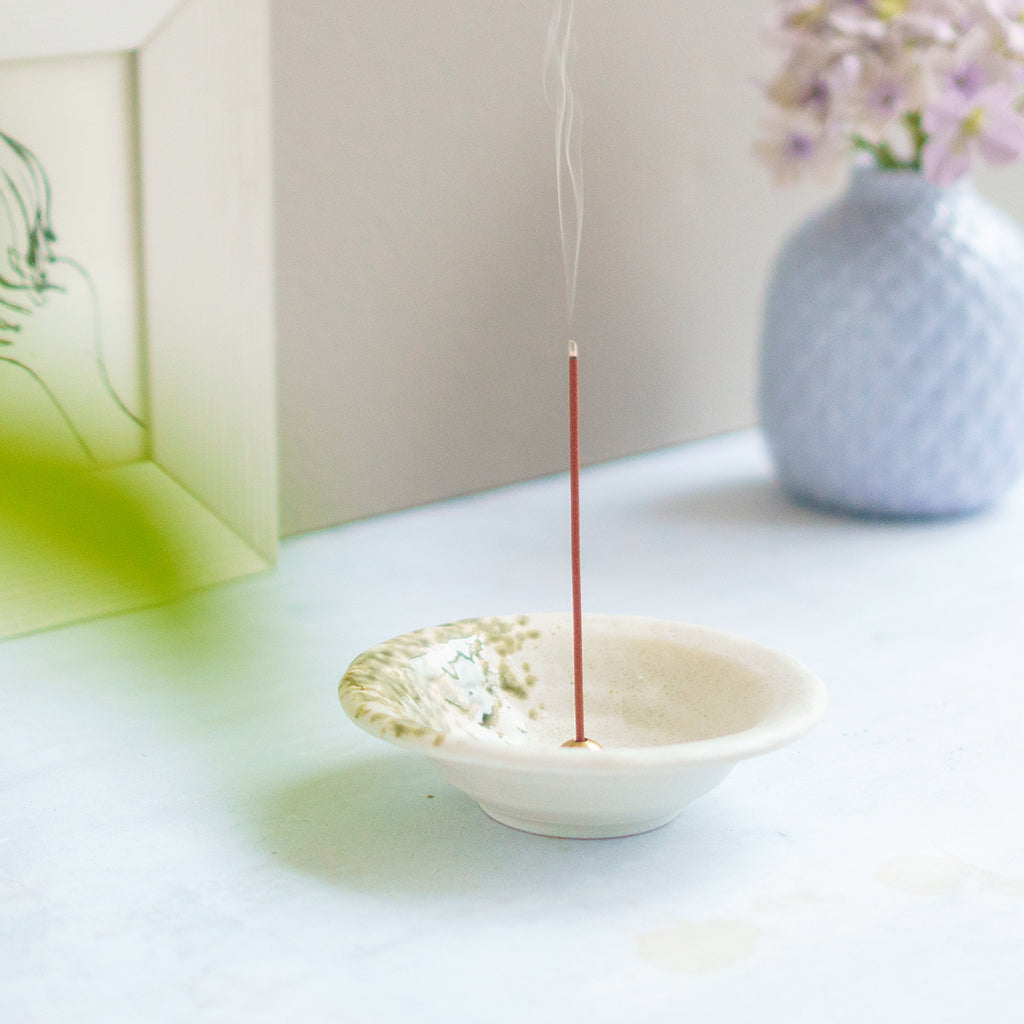 incense burning in white incense holder