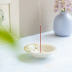 incense burning in white incense holder